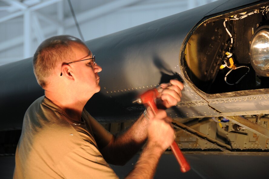 Master Sergeant Rex Bonnes, 185th Air Refueling Wing, Sioux City Iowa, removes rivets from the sheet metal on the wing of a KC-135 in order to repair some damage caused by corrosion. 