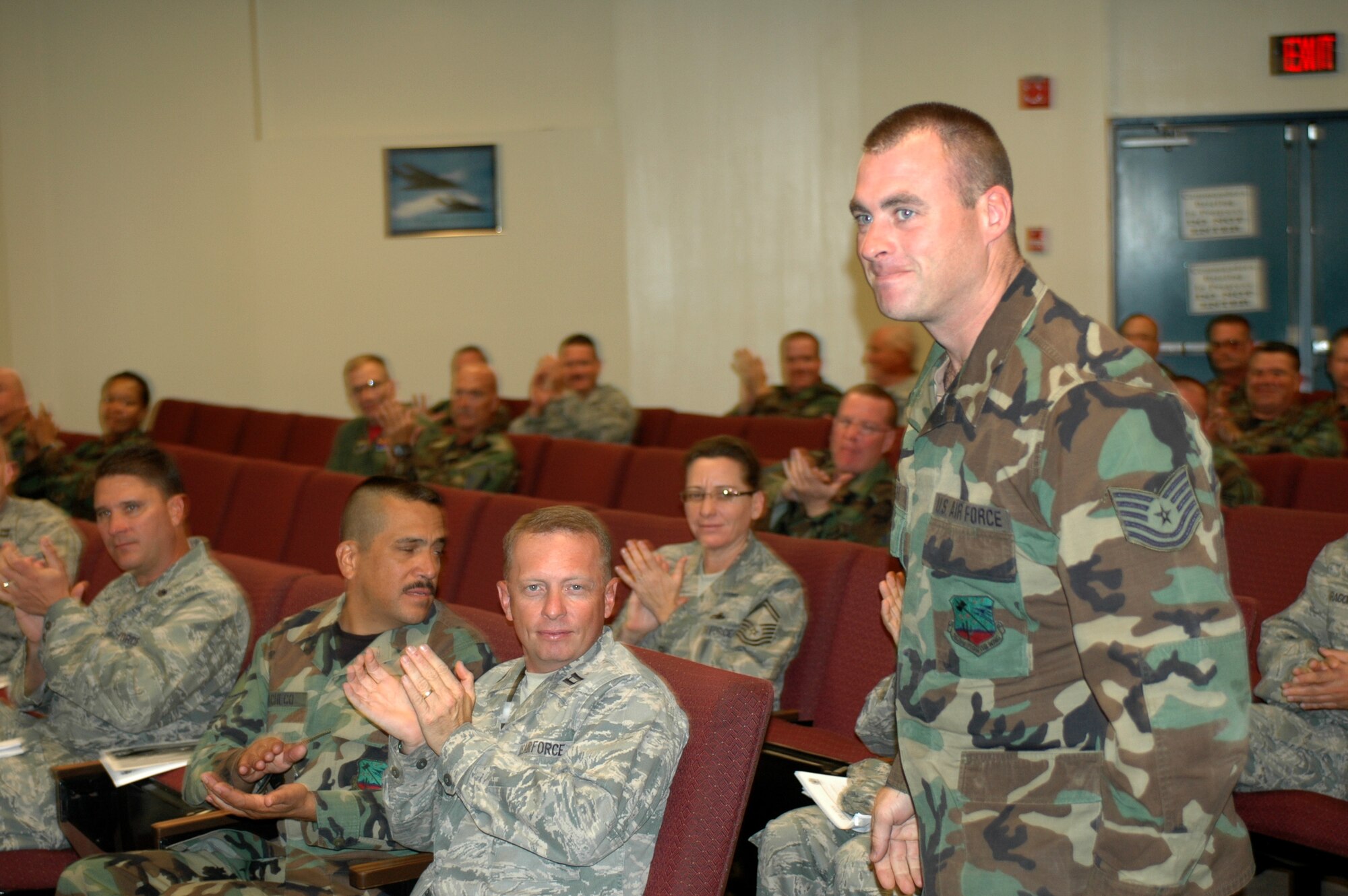 Tech. Sgt. John Mahler,148th Figther Squadron, receives applause from his co-workers for being chosen as the "Elite Performer" by Lt. Col. James Taylor, 162nd Maintenance Group Commander, Nov. 6. The Elite Performer award is a quarterly award designed to increase attentiveness to doing quality work - leaner, more efficient, and with a continuous improvement process in mind. (Air National Guard photo by Maj. Gabe Johnson).