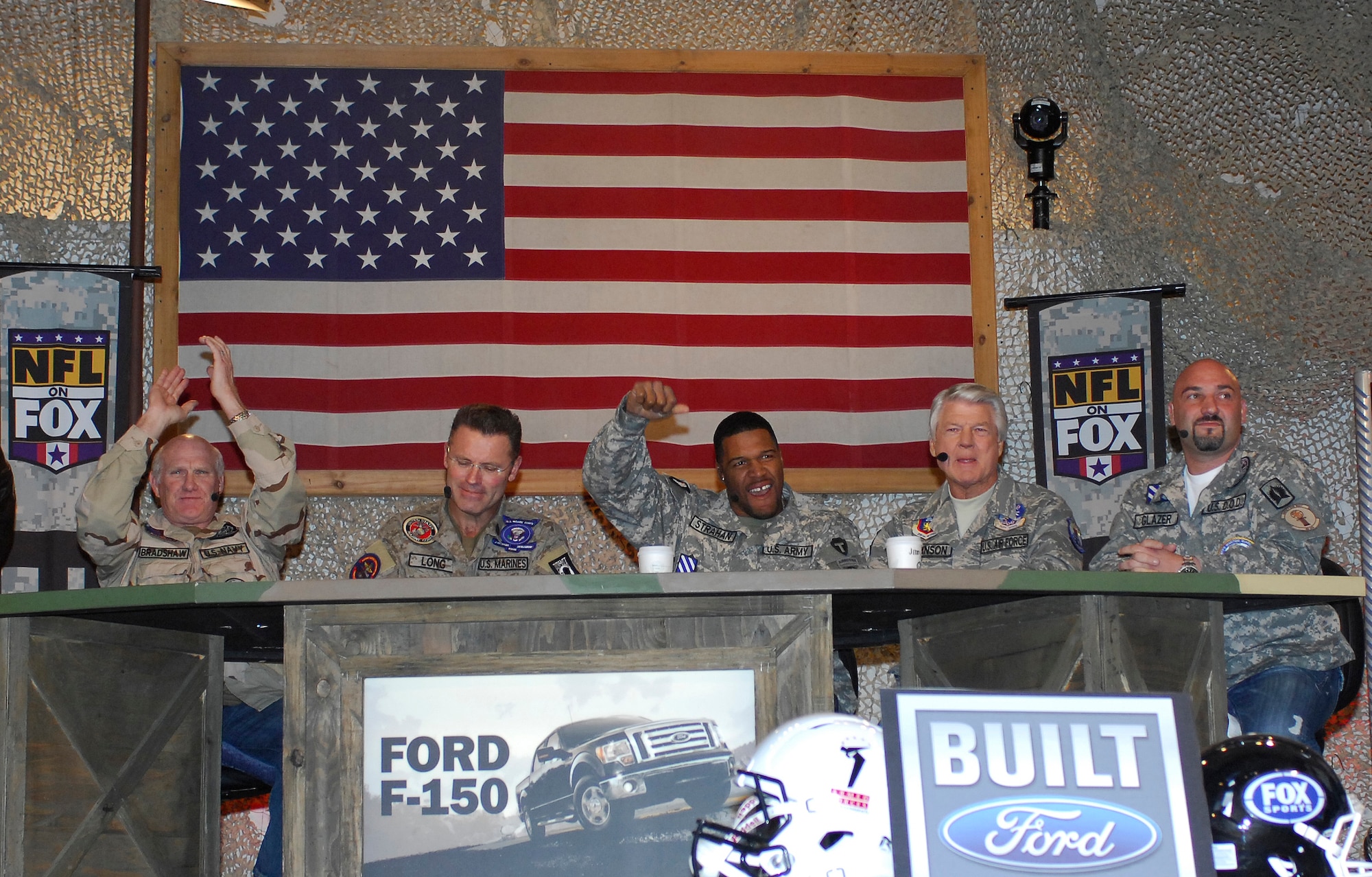 BAGRAM AIRFIELD, Afghanistan -- The FOX NFL Sunday crew gets the crowd pumped up as they prepare for the show. The team of Curt Menefee, Terry Bradshaw, Howie Long, Michael Strahan, Jimmy Johnson and Jay Glazer will do the special just three days before Veterans Day as a tribute to the dedication of America's service men and women. "Our men and women in the military put themselves in harm's way to protect everything we hold dear, and none more so than those who are stationed in the Middle East," FOX Sports Chairman David Hill said. "It is our privilege and honor to take FOX NFL Sunday to them in November, right before Veterans Day. Amidst the fun and football, it's our hope to showcase the dedication of these men and women who have to defend against a lot more than the wildcat." (U.S. Air Force photo/Tech. Sgt. John Jung)