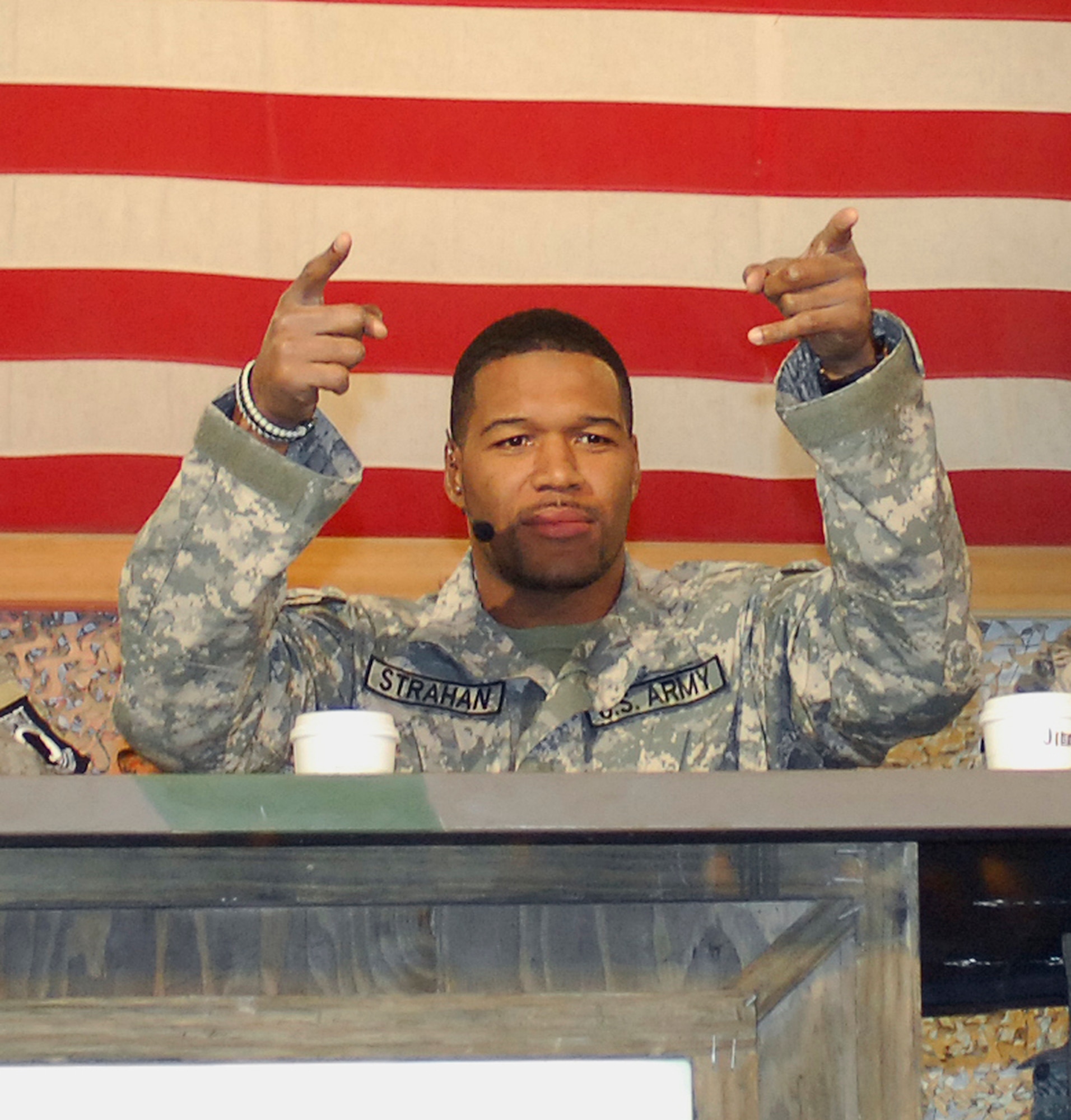 BAGRAM AIRFIELD, Afghanistan -- Michael Strahan, FOX NFL Sunday, gets the crowd of Airmen, Soldiers, Sailors and Marines fired up here Nov. 8, 2009. FOX Sports is doing the special in conjunction with Armed Forces Entertainment, the lead Department of Defense agency for providing entertainment to U.S. military personnel serving overseas. "Armed Forces Entertainment brings our men and women in uniform serving overseas a piece of home — to give them support during deployment," said Armed Forces Entertainment Chief and Air Force Col. Edward Shock. "And during football season, there's no better slice of Americana to bring to our troops overseas than the guys on FOX NFL Sunday. It's going to be one heck of an event and we salute FOX for their dedication and support of the U.S. military." (U.S. Air Force photo/Tech. Sgt. John Jung)