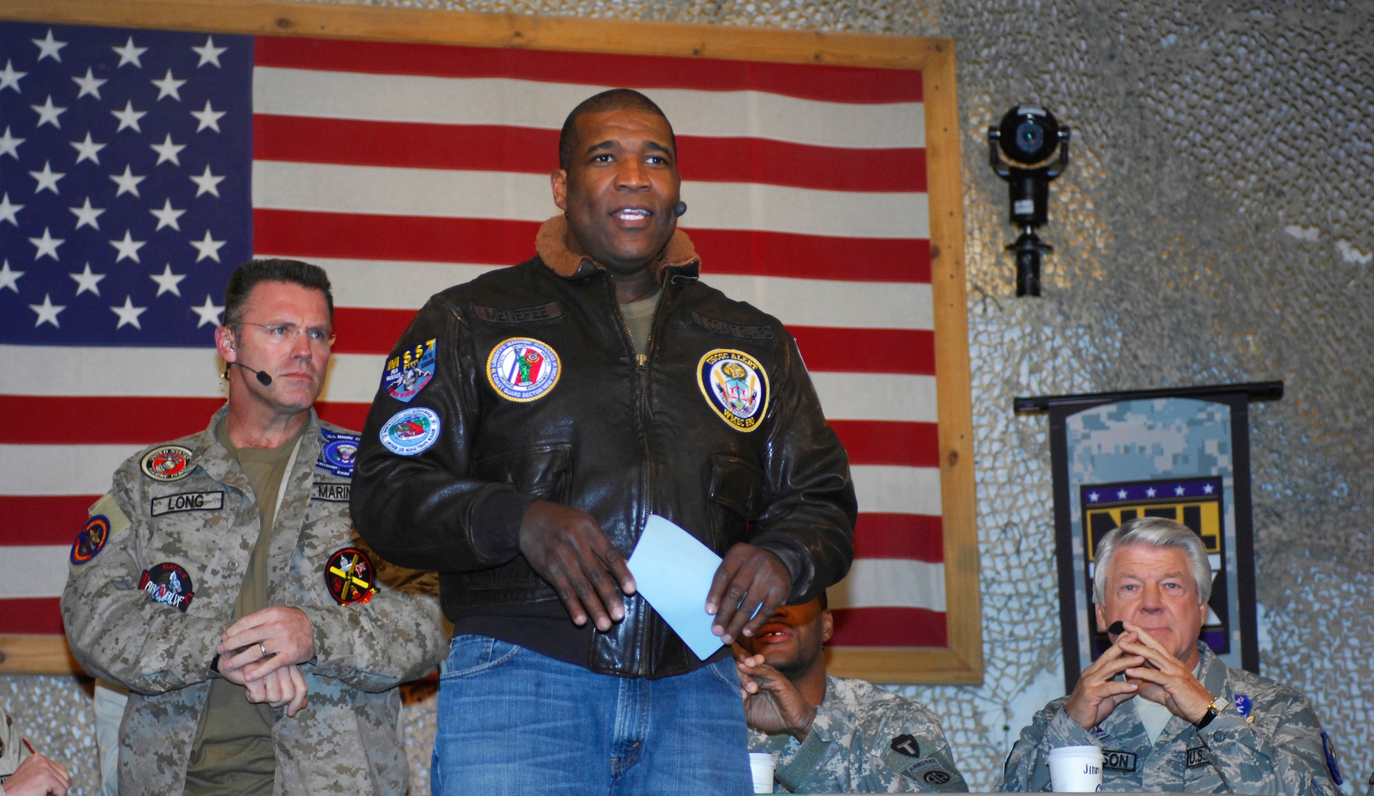 BAGRAM AIRFIELD, Afghanistan -- Curt Menefee, FOX NFL Sunday, introduces his fellow FOX sportscasters in front of a huge crowd of Airmen, Soldiers, Sailors and Marines here Nov. 8, 2009. The team of Curt Menefee, Terry Bradshaw, Howie Long, Michael Strahan, Jimmy Johnson and Jay Glazer will do the special just three days before Veterans Day as a tribute to the dedication of America's service men and women. (U.S. Air Force photo/Tech. Sgt. John Jung)