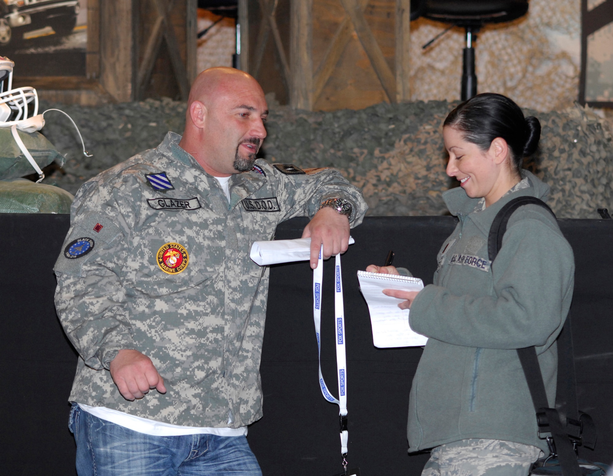 BAGRAM AIRFIELD, Afghanistan -- Jay Glazer, FOX NFL Sunday, chats with 2nd Lt. Holly Hess, a Public Affairs Officer, from Travis Air Force Base, Calif., about his experiences here. The team of Curt Menefee, Terry Bradshaw, Howie Long, Michael Strahan, Jimmy Johnson and Jay Glazer will do the special just three days before Veterans Day as a tribute to the dedication of America's service men and women. (U.S. Air Force photo/Tech. Sgt. John Jung)