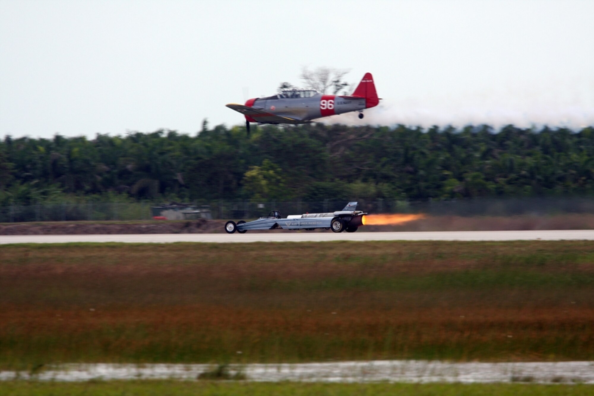The Air Force Reserve Command Jet Car races an airplane during the Wings Over Homestead Air Show, Nov. 7-8. (U.S. Air Force photo/Tech. Sgt. Bucky Parrish)