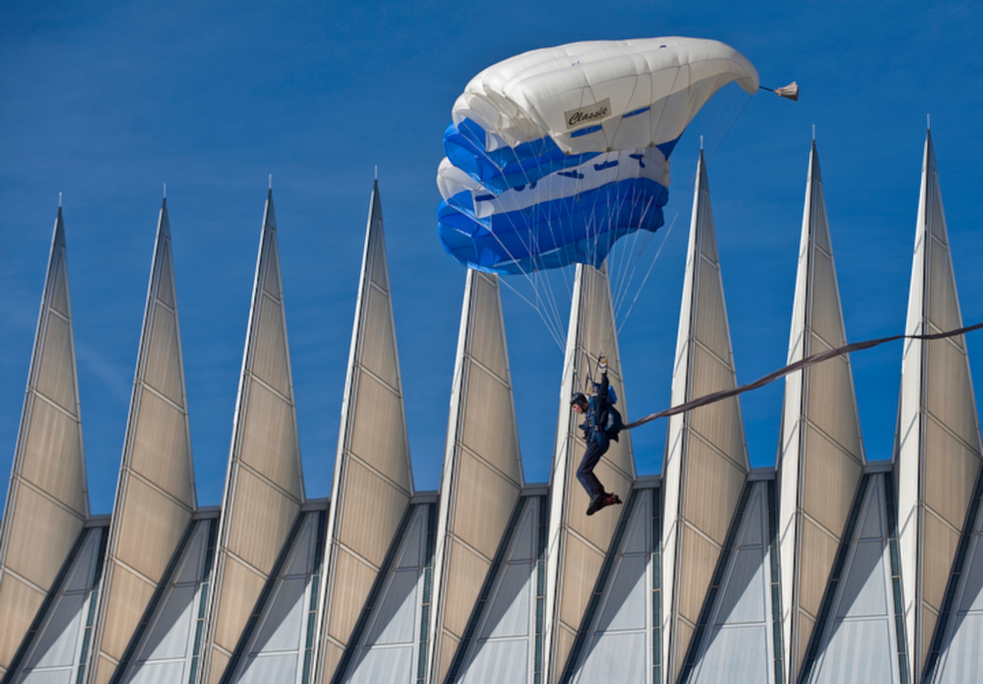A member of the U.S. Air Force Academy's Wings of Blue Parachute team maneuvers past the spires of the Cadet Chapel toward a successful landing Nov. 7 at the Terrazzo during ESPN's "College GameDay" broadcast from the Academy for the Air Force vs. Army football game in Colorado Springs, Colo. (U.S. Air Force photo/Staff Sgt. Bennie J. Davis III)