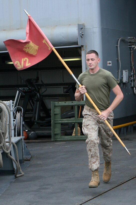 Sgt. Sean W. Miller, the platoon sergeant for Motor Transport Platoon, Combat Logistics Battalion 22, 22nd Marine expeditionary Unit, and native of Imlay City, Mich., runs with the India Company guidon Nov. 8, 2009, the fourth day of the unit’s Marine Corps Birthday celebration aboard amphibious dock landing ship USS Fort McHenry (LSD 43). Elements of CLB-22 and other Marine units aboard the ship ran 234 laps around the flight deck to commemorate the 234th anniversary of the Corps’ birth.