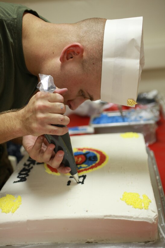Sgt. Mathew Schivers ices a cake, Nov. 9, 2009, for the 234th Marine Corps birthday celebration aboard the Intrepid Sea, Air & Space Museum. Schivers is a cook with the Special Purpose Marine Air Ground Task Force 26 , which was formed for the commissioning of USS New York.