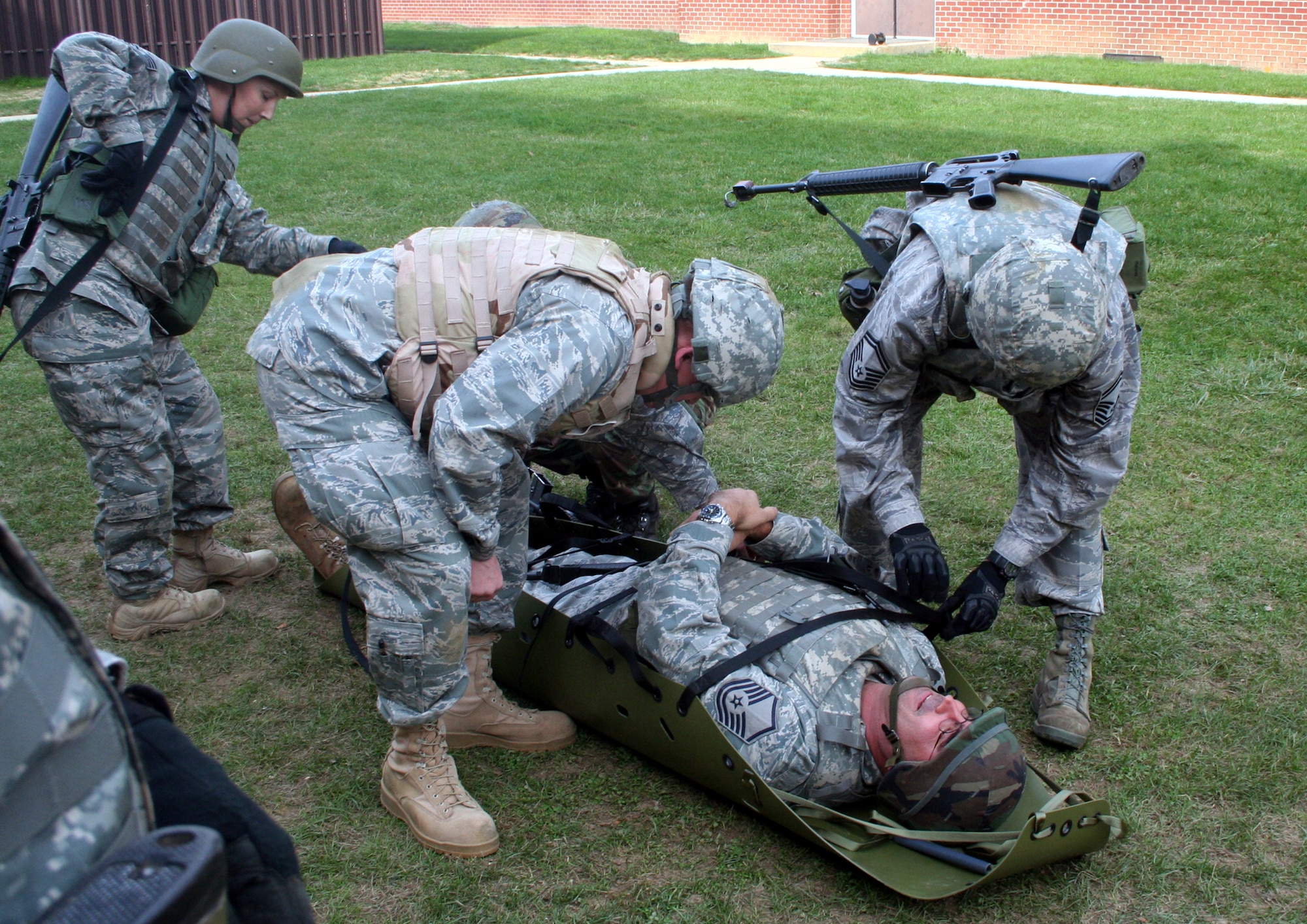 Students in the Combat Airman Skills Training Course participate in a training session of the Care Under Fire (combat first aid) class on Nov. 9, 2009, at the U.S. Air Force Expeditionary Center at Joint Base McGuire-Dix-Lakehurst, N.J.  The class, taught by the Expeditionary Center's 421st Combat Training Squadron, focuses on combat lifesaver skills.  The CAST course trains Airmen for upcoming deployments.  (U.S. Air Force Photo/Tech. Sgt. Scott T. Sturkol)