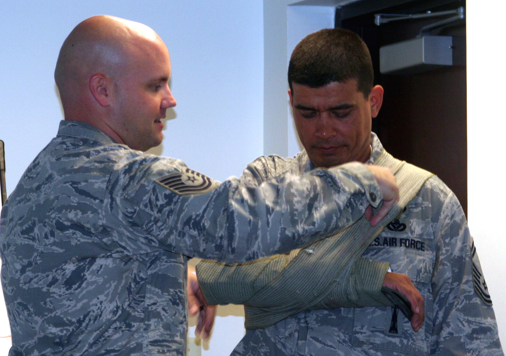 Tech. Sgt. Matt Thompson (left), independent duty medical technician and medical instructor for the U.S. Air Force Expeditionary Center's 421st Combat Training Squadron, teaches a session of the Care Under Fire (combat first aid) class to students in the Combat Airman Skills Training Course 10-1A on Nov. 9, 2009, at the center at Joint Base McGuire-Dix-Lakehurst, N.J.  The class focuses on combat lifesaver skills.  The CAST course trains Airmen for upcoming deployments.  (U.S. Air Force Photo/Tech. Sgt. Scott T. Sturkol)