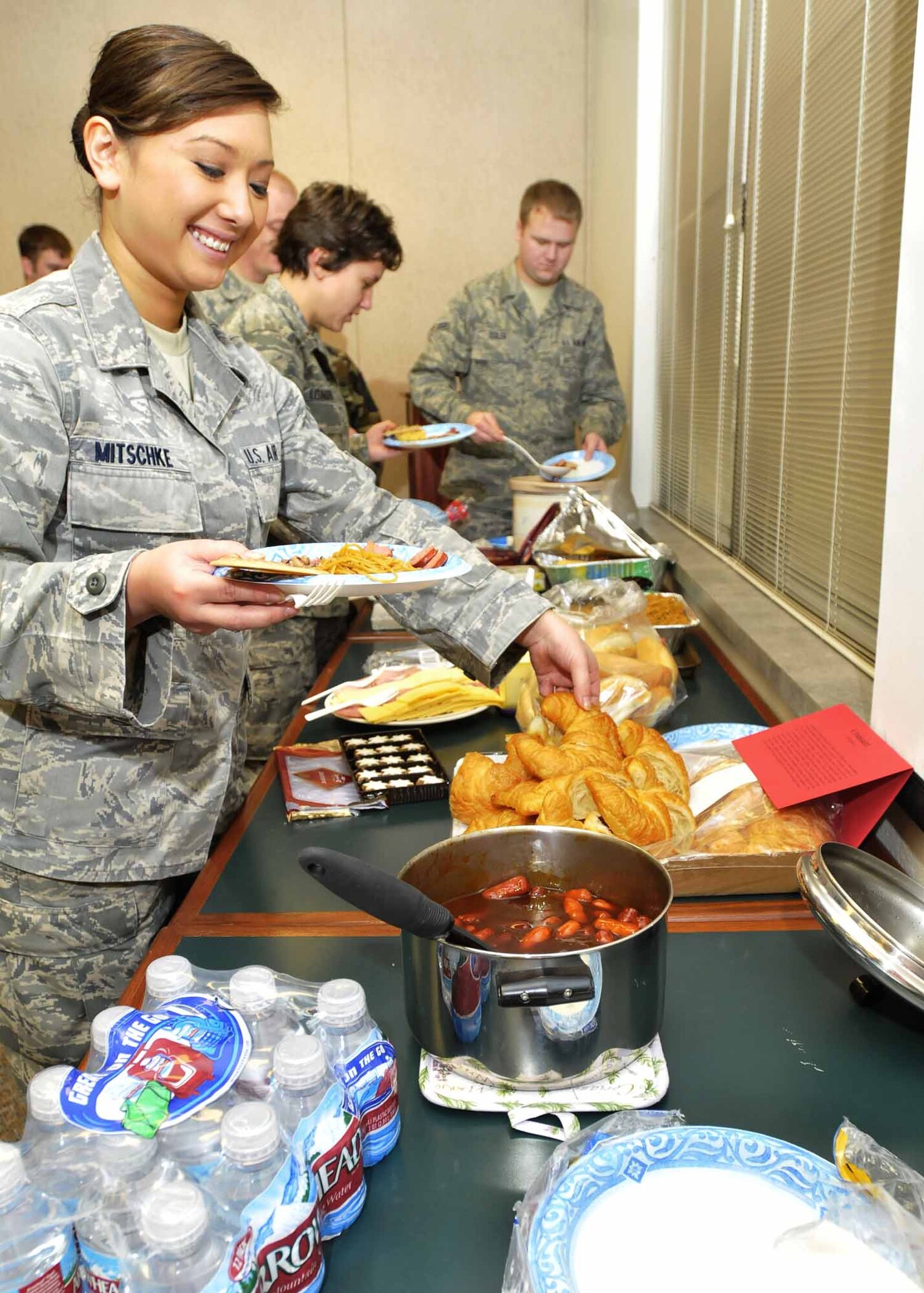 Airman 1st Class Jhangmi Mitschke, 141st Medical Group, partakes in the Diversity Council’s ethnic luncheon. The luncheon provided members the opportunity to bring in traditional dishes and discuss their cultural significance. Fairchild AFB, Wash., Nov. 8, 2009. (U.S. Air Force photo by Staff Sgt. Anthony Ennamorato/Released)