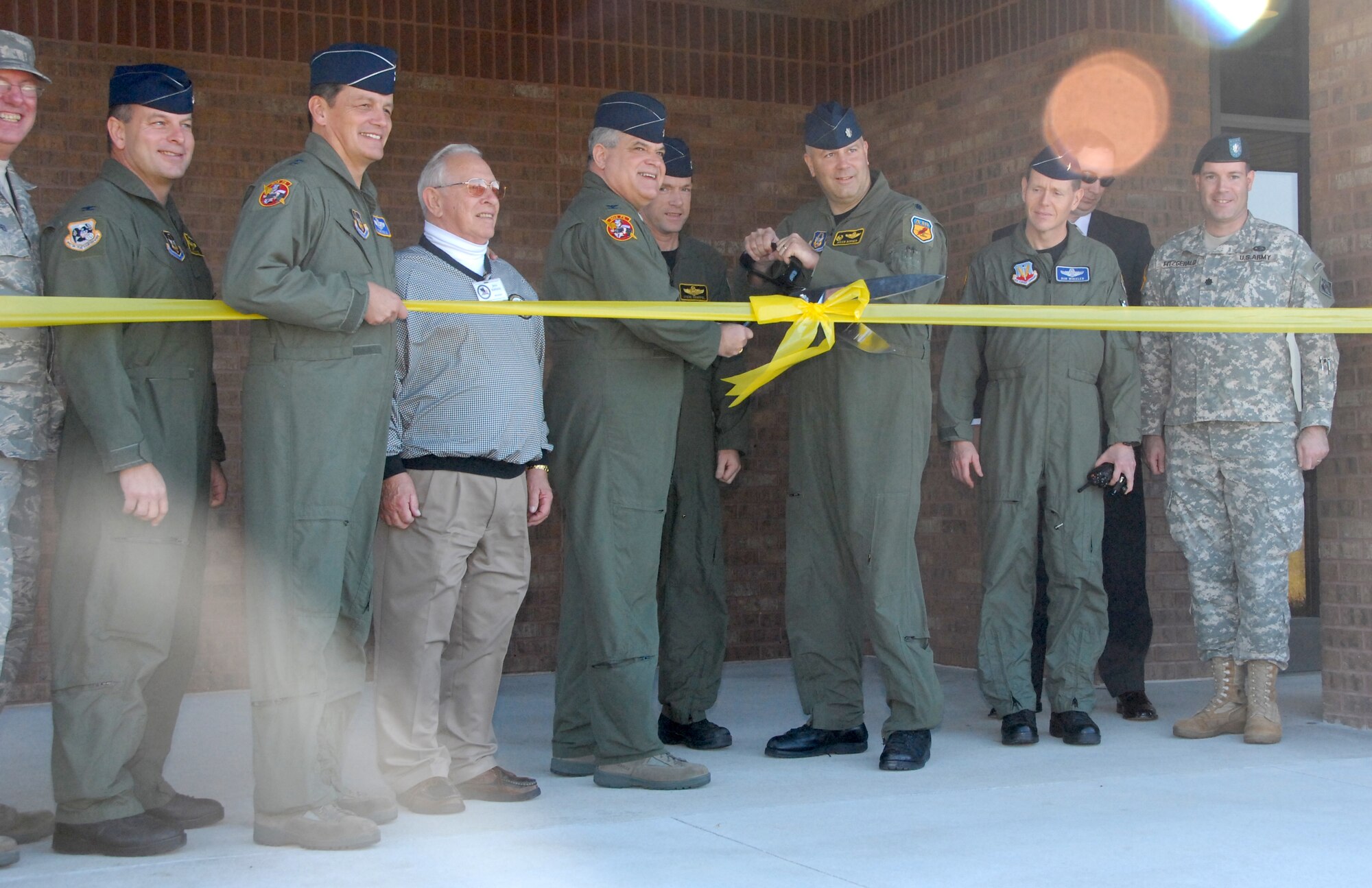Senior leaders from Whiteman Air Force Base, Mo., and the Kansas-City District of the U.S. Army Corps of Engineers cut the ribbon Nov. 7 on a new operations building constructed for the 303rd Fighter Squadron, part of the 442nd Fighter Wing, based at Whiteman.  The $8.4 million facility was recently finished and will house not only the A-10 pilots in the 303rd FS but also functions such as life support, intelligence, operations support and everything associated with operating the squadron's 27 A-10 Thunderbolt II aircraft.  The squadron has a history dating back to 1943 and more recently has deployed four times to Iraq and Afghanistan.  The A-10 provides close-air support to combat ground forces.  The Army Corps of Engineers oversaw the design and construction of the building, which took two years to complete.  From left to right are:  Chief Master Sgt. Allan Sturges, 442nd Fighter Wing command chief; Col James Mackey, 442nd FW vice commander; Maj Gen Frank Padilla, commander of 10th Air Force; Mr. Jess Kellock, president of the Whiteman Base Community Council; Col Mark Clemons, 442nd FW commander; Lt Col Stephen Chappel, 303rd FS director of operations; Lt Col Brian Borgen, 303rd FS commander; Brig Gen Robert Wheeler, 509th Bomb Wing commander; Mr. James Rudy, engineer for the Army Corps of Engineers; and Lt Col Mike Fitzgerald, deputy commander of the Army Corps' Kansas-City District.  The 442nd is an Air Force Reserve unit based at Whiteman.  (U.S. Air Force photo/Staff Sgt. Kent Kagarise)