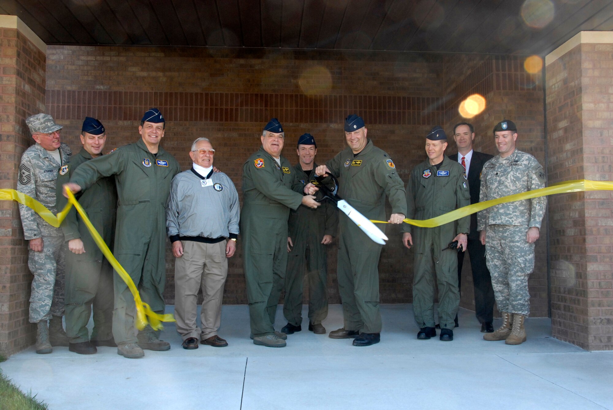 Senior leaders from Whiteman Air Force Base, Mo., and the Kansas-City District of the U.S. Army Corps of Engineers cut the ribbon Nov. 7 on a new operations building constructed for the 303rd Fighter Squadron, part of the 442nd Fighter Wing, based at Whiteman.  The $8.4 million facility was recently finished and will house not only the A-10 pilots in the 303rd FS but also functions such as life support, intelligence, operations support and everything associated with operating the squadron's 27 A-10 Thunderbolt II aircraft.  The squadron has a history dating back to 1943 and more recently has deployed four times to Iraq and Afghanistan.  The A-10 provides close-air support to combat ground forces.  The Army Corps of Engineers oversaw the design and construction of the building, which took two years to complete.  From left to right are:  Chief Master Sgt. Allan Sturges, 442nd Fighter Wing command chief; Col James Mackey, 442nd FW vice commander; Maj Gen Frank Padilla, commander of 10th Air Force; Mr. Jess Kellock, president of the Whiteman Base Community Council; Col Mark Clemons, 442nd FW commander; Lt Col Stephen Chappel, 303rd FS director of operations; Lt Col Brian Borgen, 303rd FS commander; Brig Gen Robert Wheeler, 509th Bomb Wing commander; Mr. James Rudy, engineer for the Army Corps of Engineers; and Lt Col Mike Fitzgerald, deputy commander of the Army Corps' Kansas-City District.  The 442nd is an Air Force Reserve unit based at Whiteman.  (U.S. Air Force photo/Maj. David Kurle)