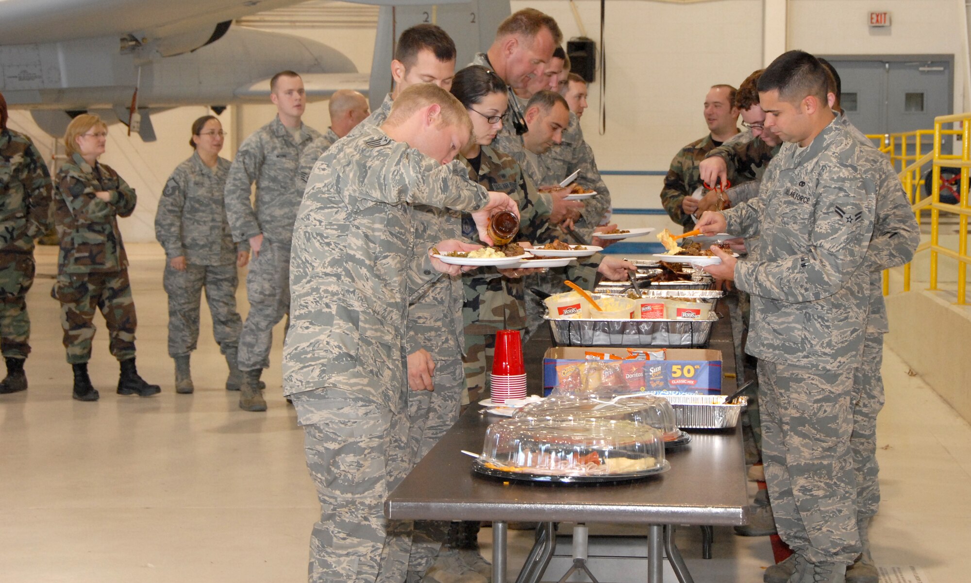Citizen Airmen from the 442nd Fighter Wing pile their plates high with barbecue, beans, potato salad and other food during a barbecue dinner cooked by a group of volunteers from Fishnet Security, INC., a company based in Kansas City.  Volunteers from the company prepared a feast for 1,200 Air Force Reservists from the 442nd Fighter Wing Nov. 7, 2009, at Whiteman Air Force Base, Mo.  Volunteers have been cooking for more than four years to say "thank you" to military members for their sacrifices and service.  (U.S. Air Force photo/Tech. Sgt. Spirit Spencer)