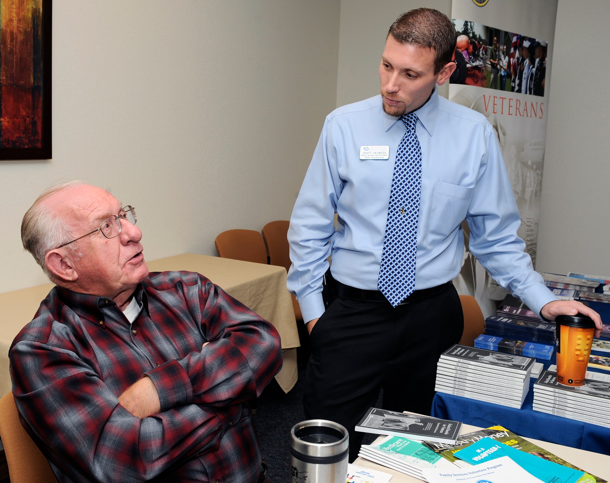 HOLLOMAN AIR FORCE BASE, N.M. -- Mr. Robert Brown, family services volunteer program representative for the Airman and Family Readiness Center, speaks with Scott Lajiness, U.S. Department of Veterans Affairs coordinator, during the Retiree Activities Day event here, Nov. 5. Mr. Brown reminisced about his time serving in the U.S. Air Force and welcomed all retirees who attended.  The event was one of many activities that celebrated Week of the Air Force Family. (U.S. Air Force photo by Airman 1st Class Veronica Stamps)