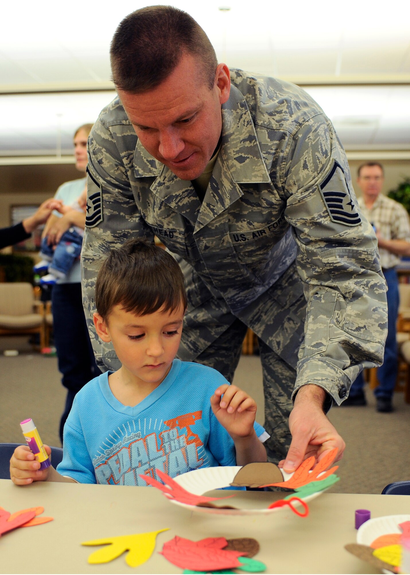 HOLLOMAN AIR FORCE BASE, N.M. -- Master Sgt. James Moorehead, 4th Space Control Squadron, creates a colorful wreath with his son, Robert, at Ahren's Memorial library here, Nov. 4. The library hosted "Military Family Read Time" that involved storybook reading and crafts to celebrate the Week of the Air Force Family. (U.S. Air Force photo by Airman 1st Class Veronica Stamps)