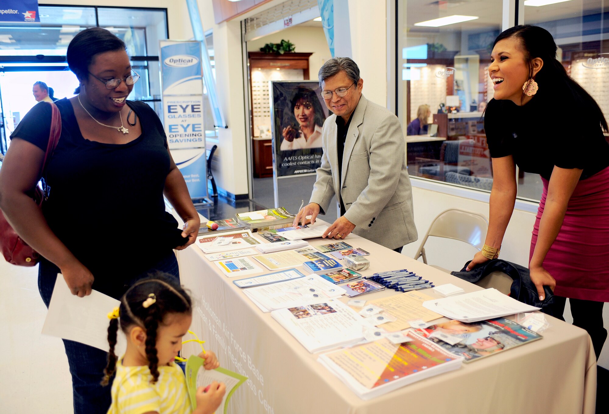 HOLLOMAN AIR FORCE BASE, N.M. -- Verlean Coman, wife of Staff Sgt. Jason Coman, 49th Maintenance Squadron, views a table display presented  by the Airman and Family Readiness center  at the Base Exchange here, Nov. 3.  Mrs. Coman and her daughter, Mya, were given information regarding events and resources that celebrated the Week of the Air Force Family. (U.S. Air Force photo by Airman 1st Class Veronica Stamps)