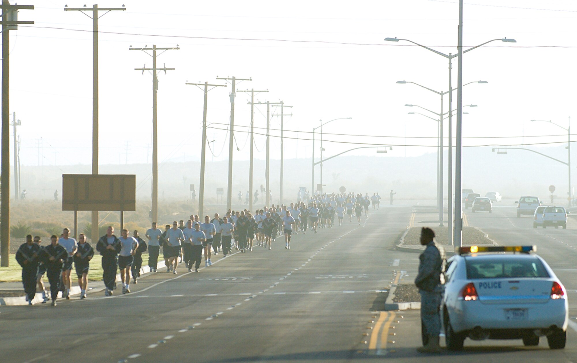 95th Security Forces Squadron Airmen clear intersections to ensure safety while Airmen and their families take part in the five kilometer family walk/run, which kicked off Wingman Day Nov. 6. Wingman Day was part of the Year of the Air Force Family Initiative being celebrated from July 2009 to July 2010. (Air Force photo/Mike Cassidy)