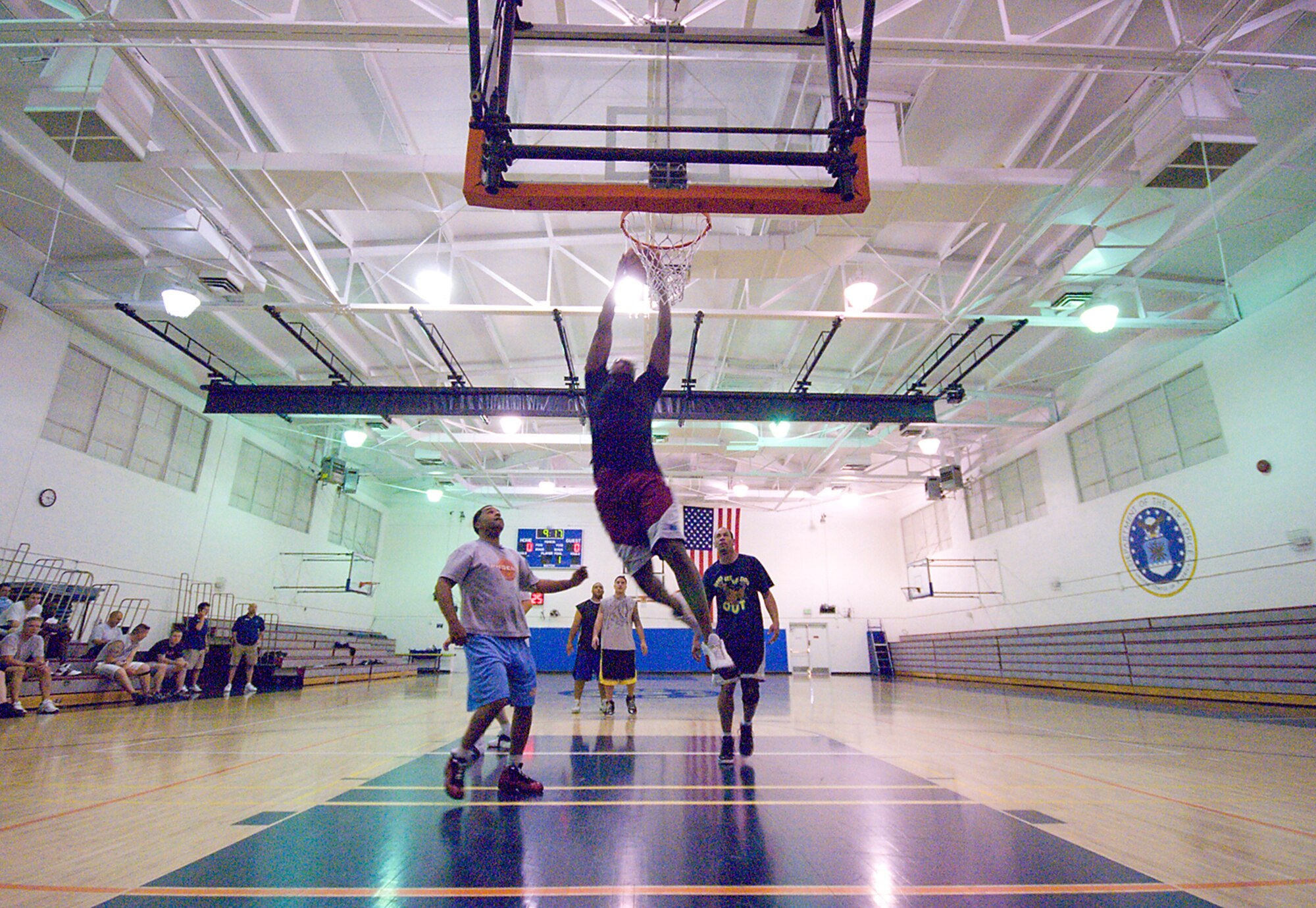 Senior Airman Marcel Ford, 412th Aircraft Maintenance Squadron maintainer, slam dunks during a game of three-on-three basketball at the Rosburg Fitness Center during Wingman Day Nov. 6. Wingman Day offered various information booths at the Oasis Community Center and various sports and activities held at the gym. (Air Force photo/Mike Cassidy)