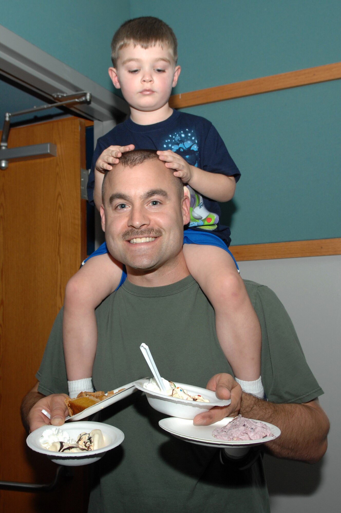 WHITEMAN AIR FORCE BASE Mo. – Senior Master Sgt.  Zachary Capogna, member of the 509th Maintenance Squadron, and son Riley enjoy the afternoon at the pie and ice cream social held at the Community Center here Saturday Nov. 7.  The social was part of the Team Whiteman Month of the Military family in November. The Month of the military family is in conjunction with the Air Forces Year of the Air Force Family program from July of 2009 to July of 2010. ( U.S. Air Force Photo/ Senior Airman Jessica Mae Snow) (Released)