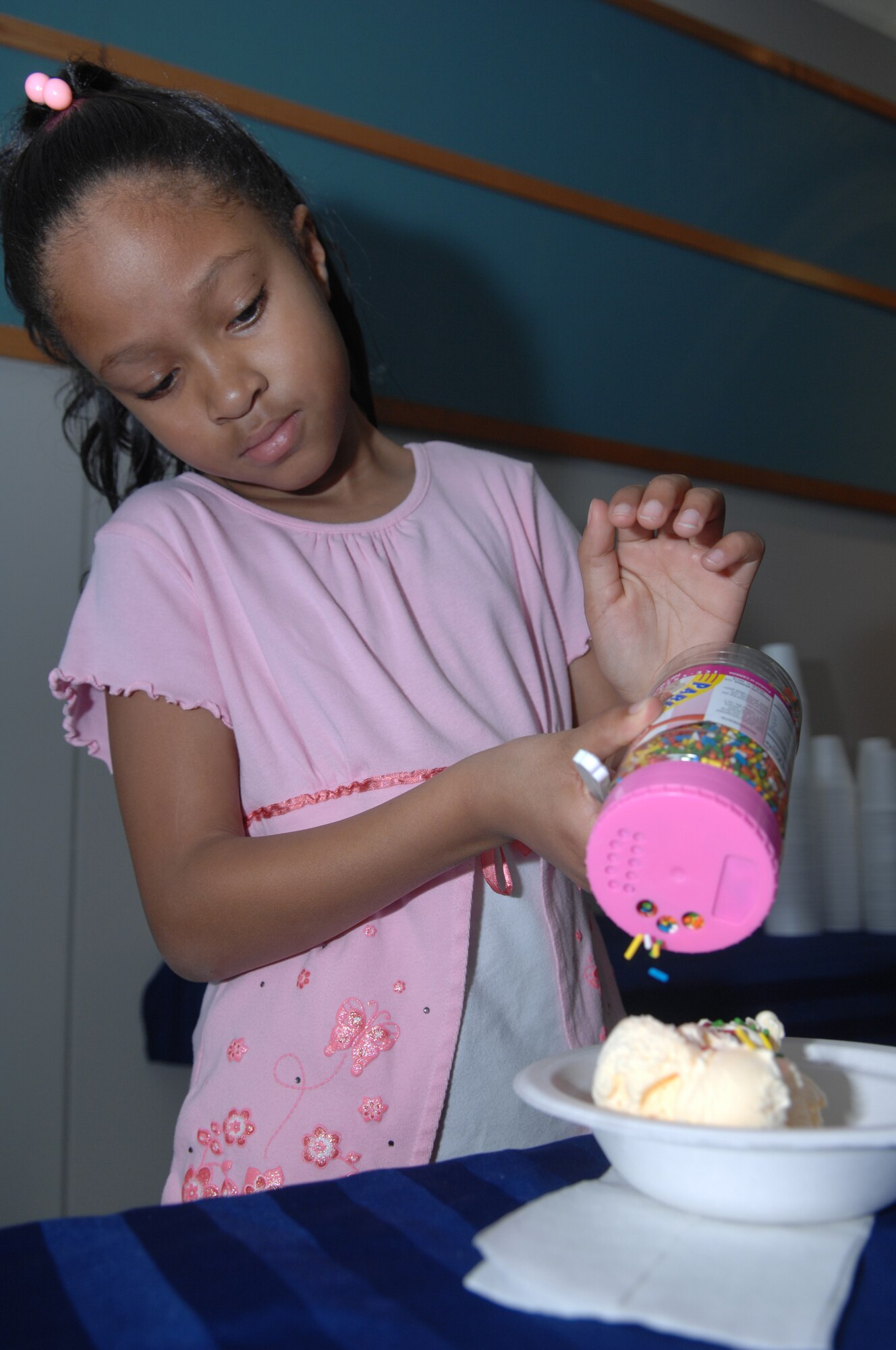 WHITEMAN AIR FORCE BASE Mo. – Erin, daughter of, 509th Bomb Wing Vice Commander Col. Rickey Rodgers, prepares her bowl of ice cream during the Pie Ice Social held at the Community Center here Nov. 7.  The social was part of the Team Whiteman Month of the Military family in November. The Month of the military family is in conjunction with the Air Forces Year of the Air Force Family program from July of 2009 to July of 2010. ( U.S. Air Force Photo/ Senior Airman Jessica Mae Snow) (Released) 