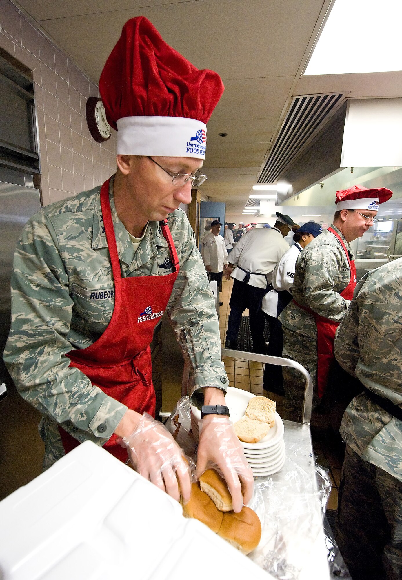 Maj. Gen. James T. Rubeor, 22nd Air Force commander, along with commanders from the 512th Airllift Wing, serves lunch to Reserve Airmen at the Patterson Dining Faciilty here Nov. 7. The general visited the 512th AW Nov. 5-8. (U.S. Air Force photo/Roland Balik)