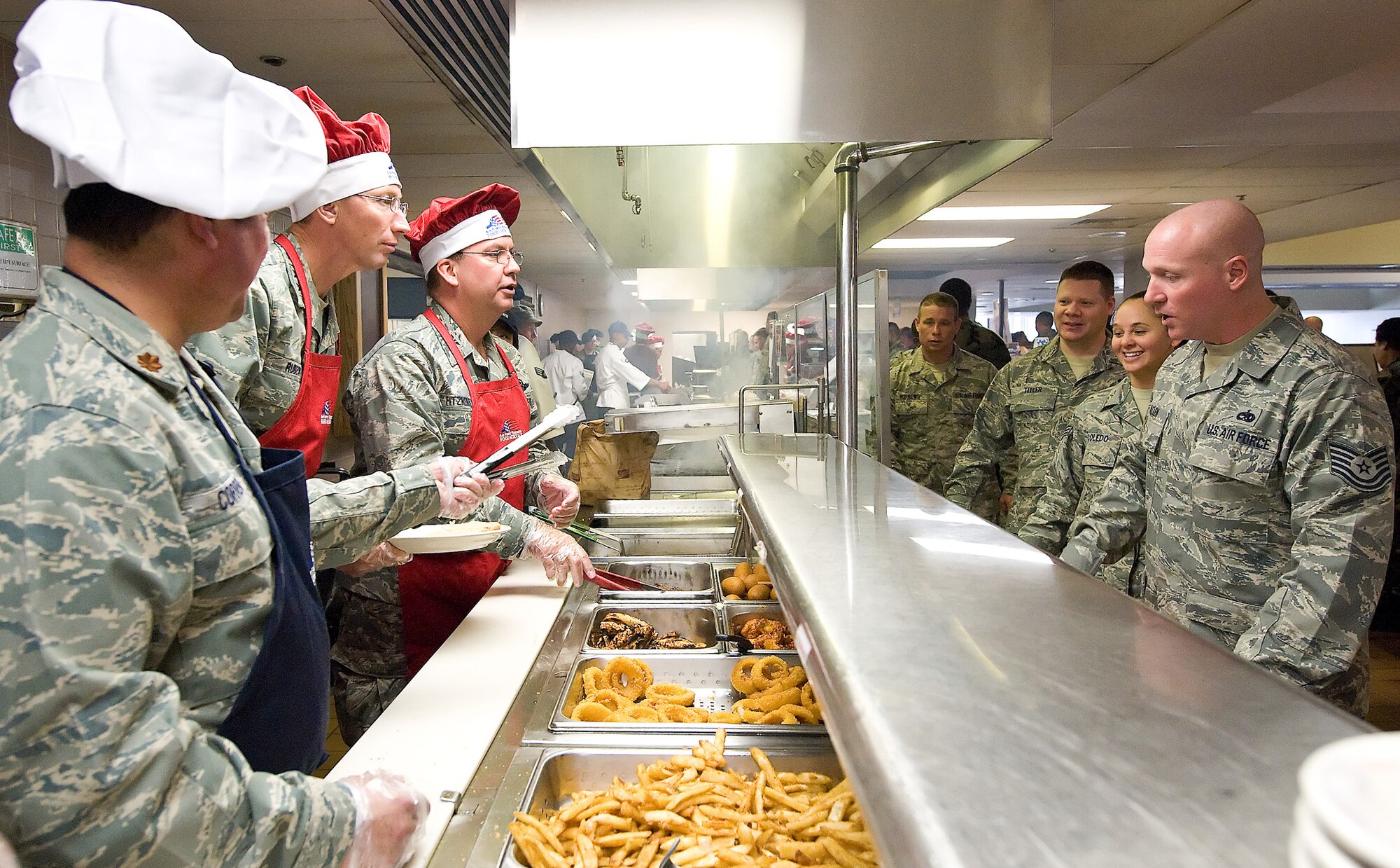 Maj. Gen. James T. Rubeor, 22nd Air Force commander, and Col. Michael T. Fitzhenry, 512th Airlift Wing commander, serve lunch to Reserve Airmen at the Patterson Dining Facility here Nov. 7. General Rubeor visited the Liberty Wing Nov. 5-8. (U.S. Air Force photo/Roland Balik)