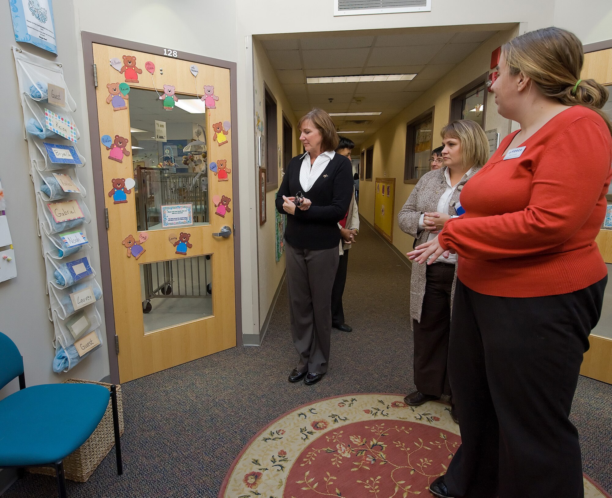 Michele Rubeor, left, wife of 22nd Air Force Commander Maj. Gen. James T. Rubeor, tours the Dover Air Force Base Child Development Center Nov. 6. During her visit here Nov. 5-8, Mrs. Rubeor met with the staff at 512th Airman and Family Readiness, interacted with spouses during a Key Spouses forum, and visited Youth Center. (U.S. Air Force photo/Brianne Zimny)