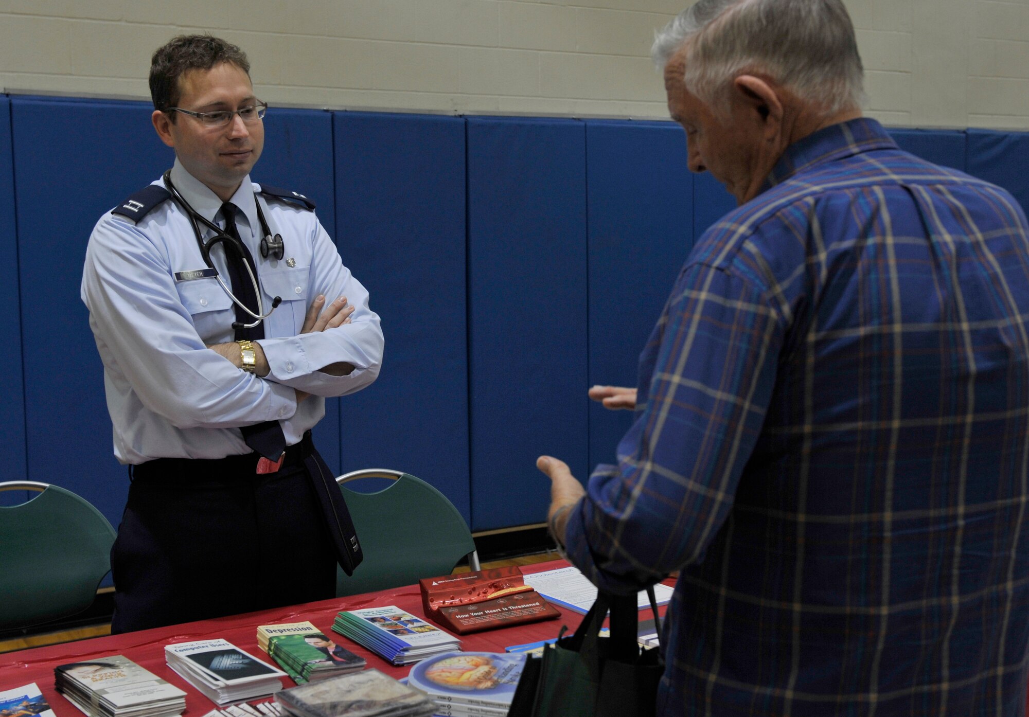 MOODY AIR FORCE BASE, Ga. -- Capt. Bradley Meyer, 23rd Medical Group Family Practice physician, speaks with a retiree from the local community here Nov 7. Captain Meyer volunteered to discuss the importance of men’s health screening during the Retiree Appreciation Week event. (U.S. Air Force photo by Senior Airman Schelli Jones)