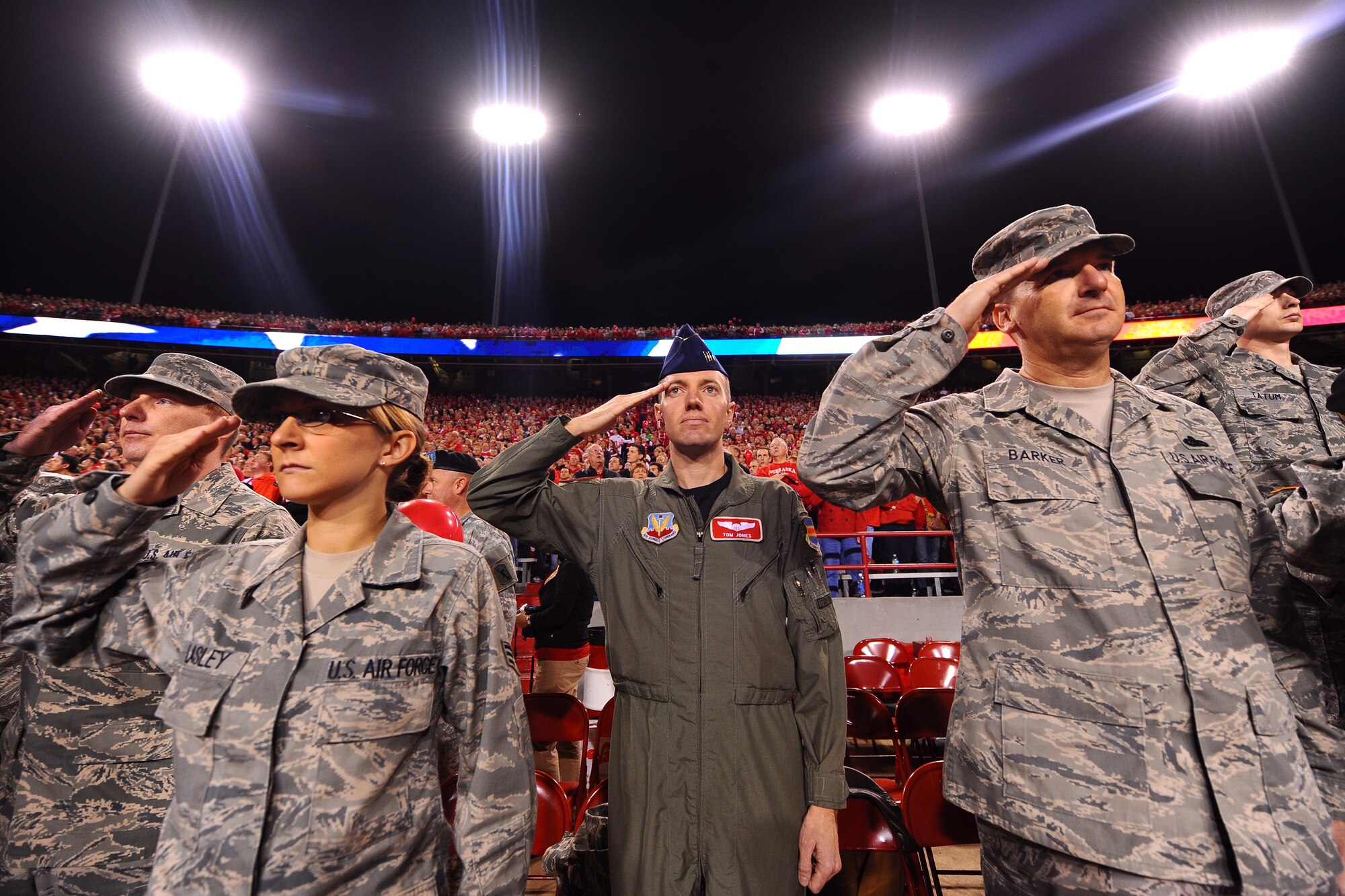 OFFUTT AIR FORCE BASE, Neb. - Senior Airman Sara Lasley, Capt. Tom Jones, and Master Sgt. Scott Barker, representing the 55th Wing and U.S. Strategic Command, salute as the National Anthem plays at Memorial Stadium, Lincoln, Neb., before the University of Nebraska's military appreciation football game against Oklahoma University Nov.7. The university invited members of the military to attend the game to thank them for their service. U.S. Air Force photo by Josh Plueger
