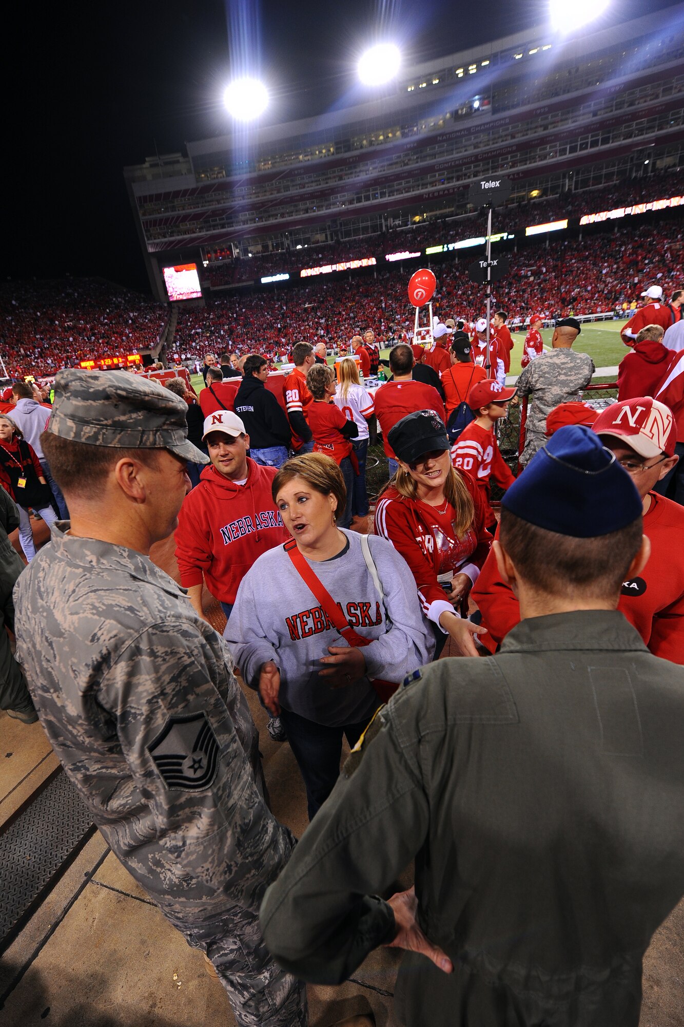 OFFUTT AIR FORCE BASE, Neb. - Shelly Gowen, a Roseland, Neb., native, thanks members of Team Offutt for their service during the University of Nebraska's military appreciation football game against Oklahoma, at Memorial Stadium in Lincoln, Neb., Nov. 7.  The university invited members of the military to attend the game to thank them for their service. U.S. Air Force photo by Josh Plueger
