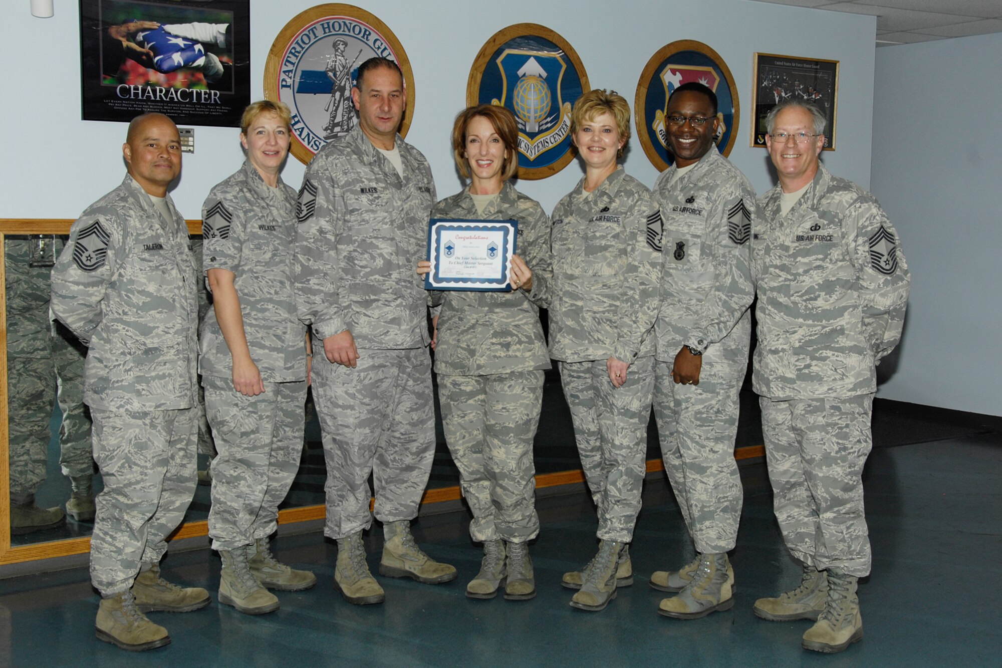 HANSCOM AIR FORCE BASE, Mass. – Senior Master Sergeant Laura Noel, 66th Force Support Squadron is congratulated on her selection for promotion to the rank of Chief Master Sergeant at the Patriot Honor Guard facility Nov. 5. Offering their congratulations and welcoming Sergeant Noel to the rank of Chief are: (left to right) Chief Master Sergeants’ Glenn Taijeron, Laura Wilkes, Alfred Wilkes, Ginger Thompson, Al Thompson, and Dave Long.  (U.S. Air Force photo by Linda LaBonte Britt)