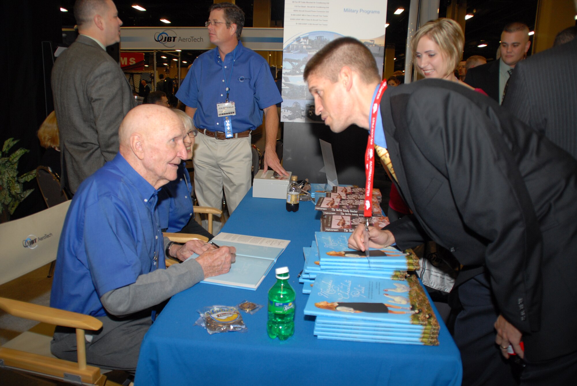 Col. Gail Halvorsen, the "Candy Bomber,” (left) signs a book Oct. 30 for Captain Jeremy Gorline, 19th Airlift Wing chaplain, during the 41st Airlift/Tanker Association convention and symposium  at the Gaylord Opryland Resort and Convention Center in Nashville, Tenn. (U.S. Air Force photo by Capt. Joe Knable)