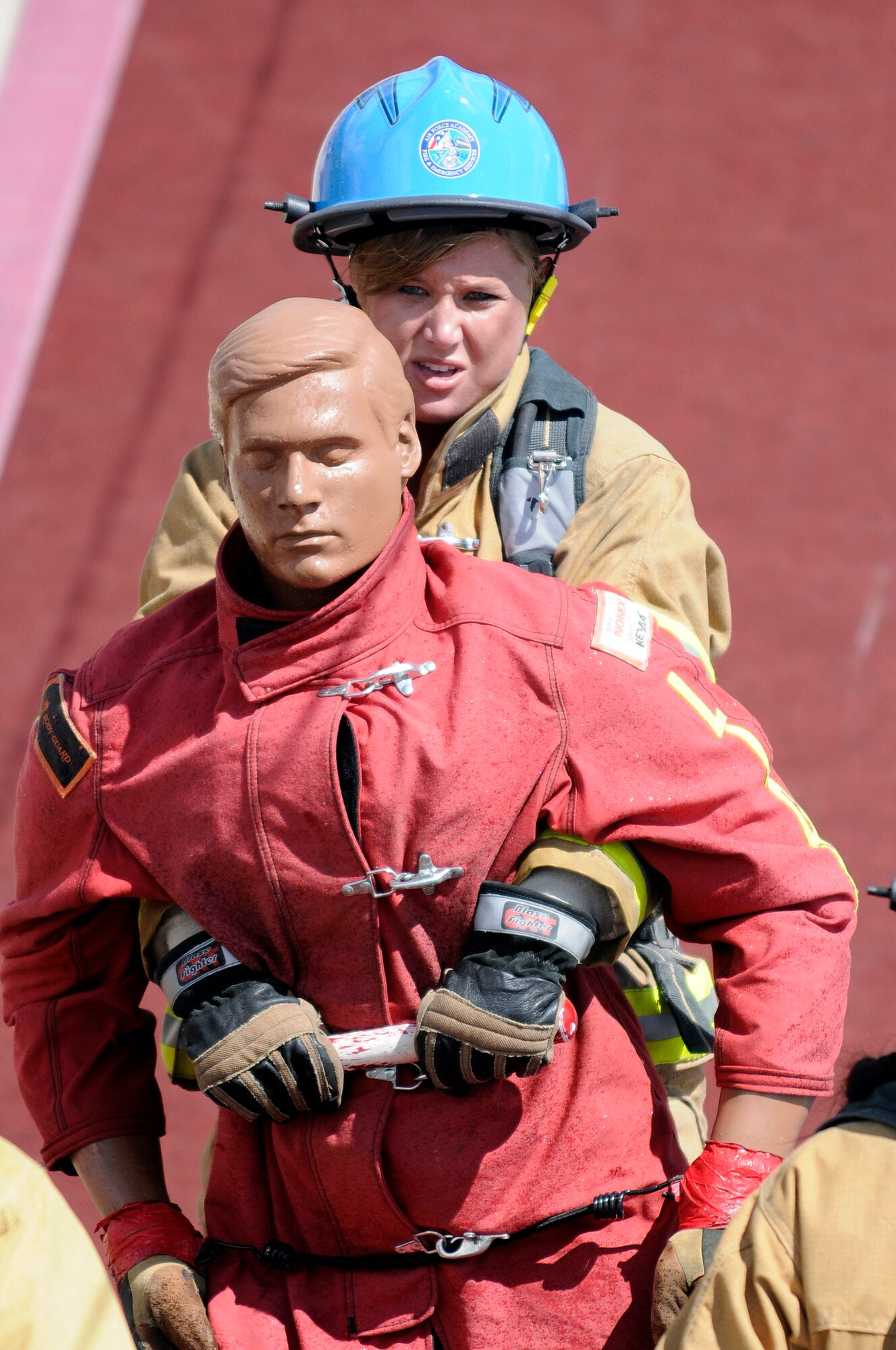Airman 1st Class Jessica Morehouse drags a rescue dummy backwards across the finish line during a firefighter combat challenge June 27, 2009. In her first-ever challenge, Airman Morehouse a member of the ladies' tandem team and the ladies' relay team at the Academy, both of which are ranked number one in the world. (U.S. Air Force photo/Mike Kaplan)