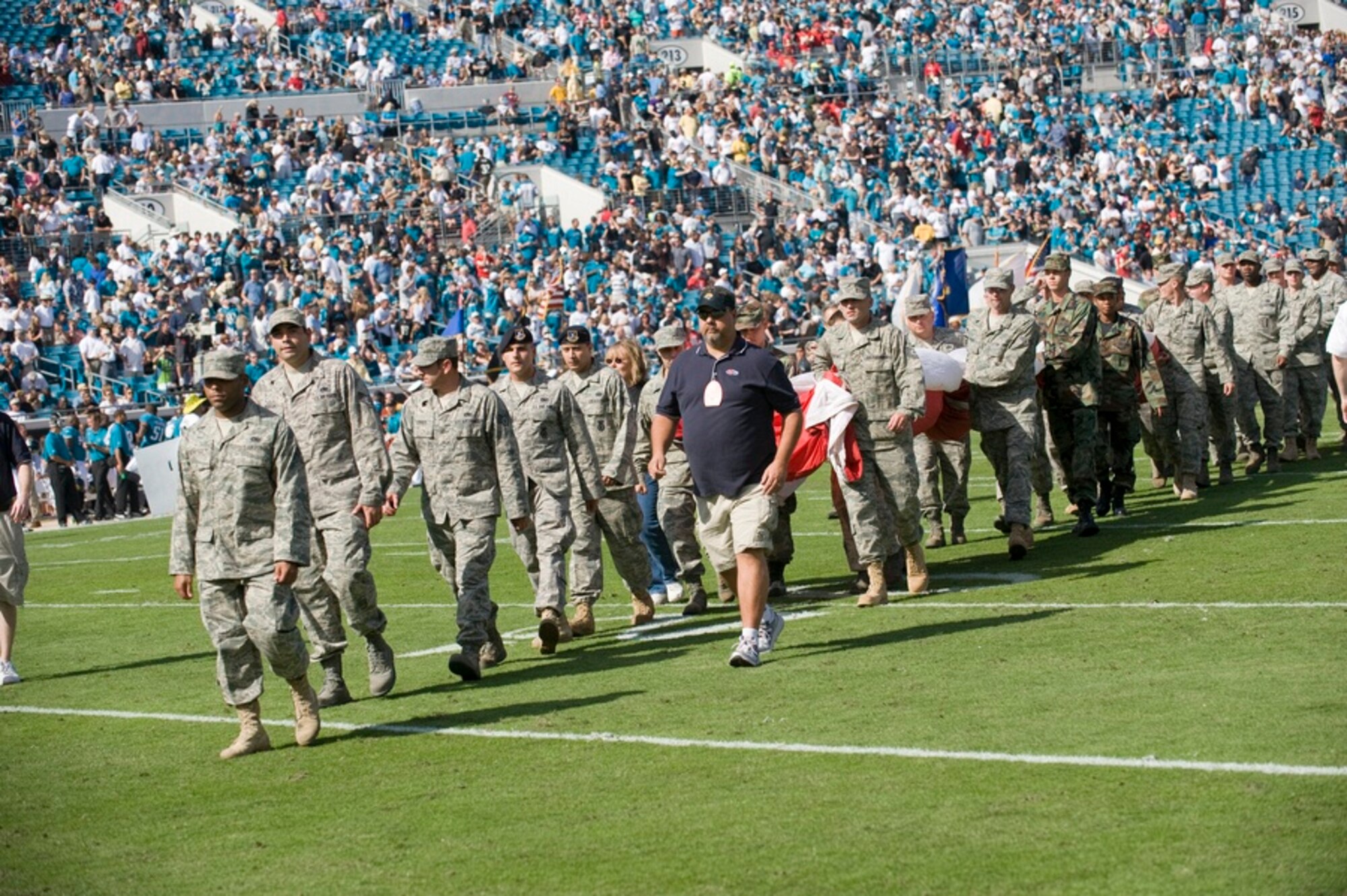 Tyndall Airmen carry the American flag off the field during a Military Appreciation Day pre-game performance at the Jacksonville Jaguars versus Kansas City Chiefs game in Jacksonville Municipal Stadium Nov. 8. (U.S. Air Force photo by Jonathan Gibson)