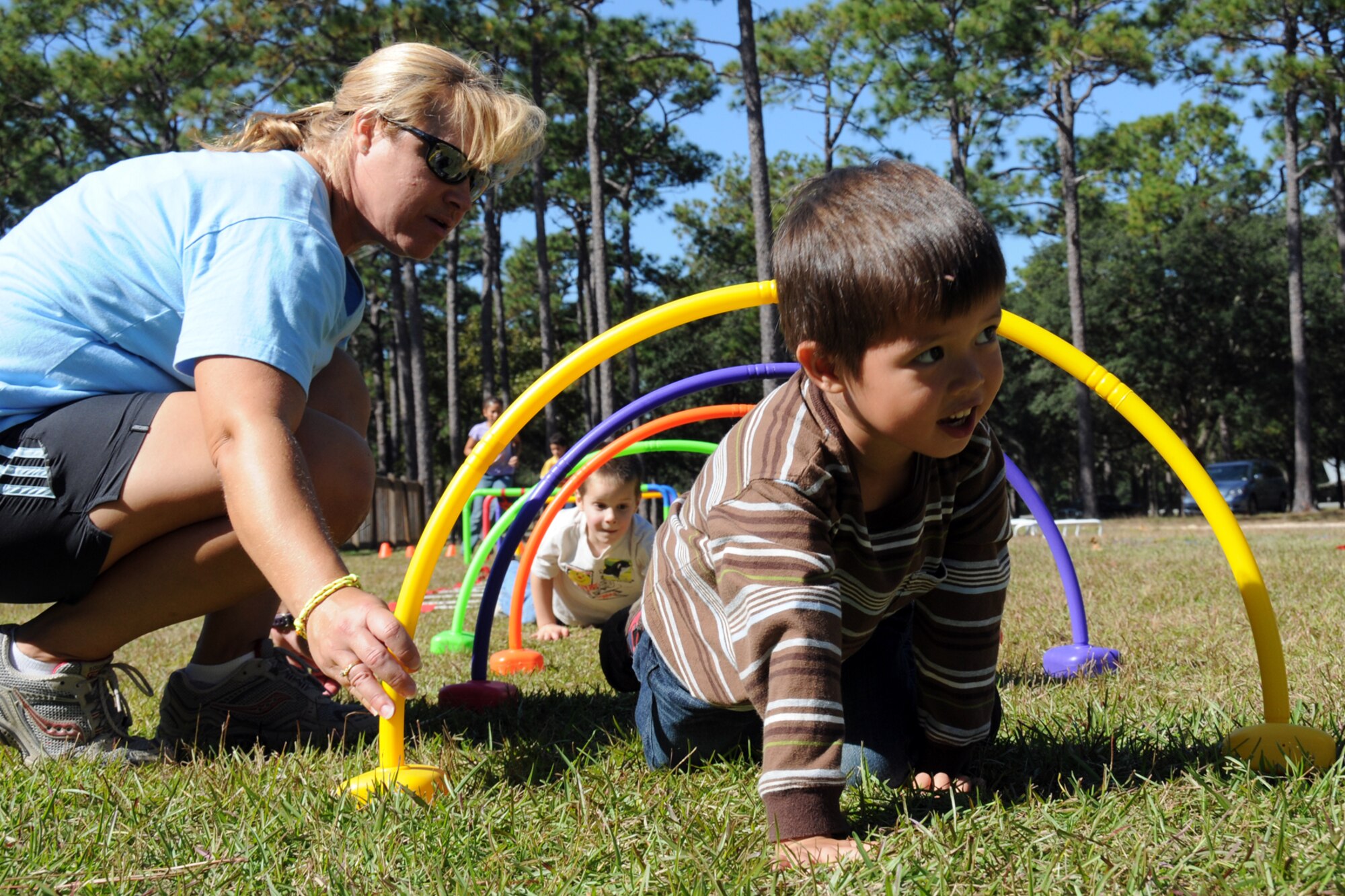 EGLIN AIR FORCE BASE, Fla. -- Children crawl through an obstacle course at the Fall Festival at Unity Park Nov. 7, during the Week of the AIr Force Family. The Team Eglin community picnic showcased base helping agencies with information booths and activities like clowns, face painting, magic shows, bouncy castle, free food and demos. (U.S. Air Force photo/Airman 1st Class Anthony Jennings)