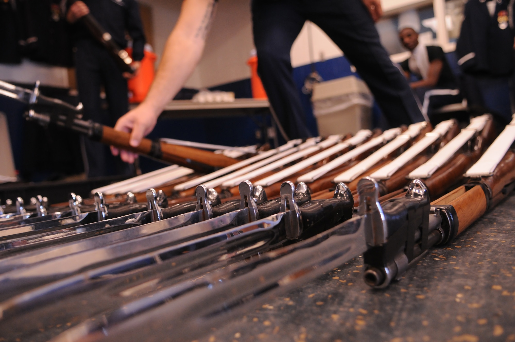 A United States Air Force Honor Guard Drill Team member places his M-1 Garand rifle with fixed bayonet in the inspection line before a performance at Randolph Air Force Base, Texas Nov. 2. The Drill Team members spin this rifle, weighing in excess of 11 pounds, up to 40 miles per hour mere inches from their bodies, making their job extremely dangerous. To prevent any injuries, each weapon is inspected before every performance to make sure it is in proper working condition. The Drill Team tours worldwide representing all Airmen while showcasing Air Force precision and professionalism and personifying the integrity, discipline, and teamwork of every Airman and every Air Force mission. During the Air Force Honor Guard's 60-year history, their traveling component, the Drill Team, has performed in every state of the union and many countries abroad. (U.S. Air Force photo by Senior Airman Sean Adams)