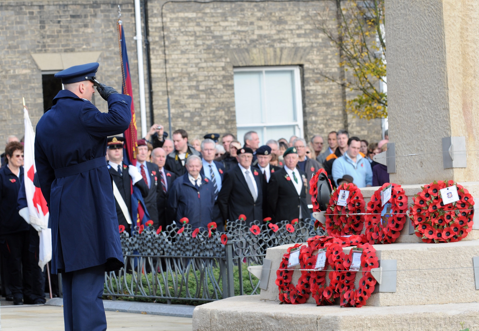 RAF MILDENHALL, England -- Col. Chad Manske, 100th Air Refueling Wing commander, salutes a poppy wreath at a Remembrance Day ceremony at Angel Hill, Bury St. Edmunds Nov. 9. Servicemembers from RAFs Mildenhall and Lakenheath participated in a military procession with British forces before the ceremony. The poppy flower is a traditional symbol of remembrance of World War I. It was at bloom across some of the worst battlefields in the war. (U.S. Air Force photo/Senior Airman Thomas Trower)