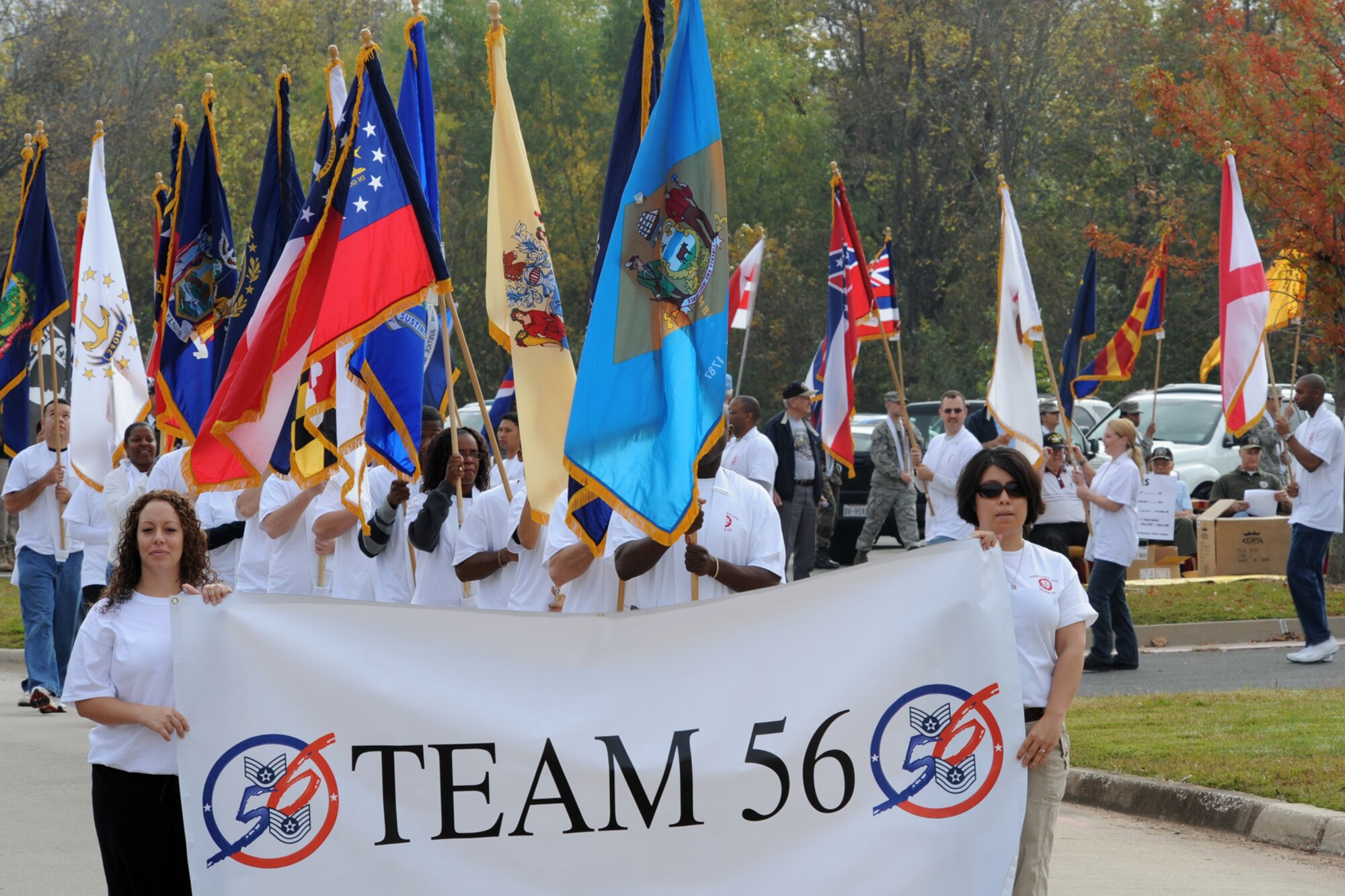 Members of TEAM 56 from Barksdale Air Force Base, La., carry flags from all 50 states during the Veteran’s Day Parade at the Bossier Parish Community College campus November 7, 2009. TEAM 56, which is comprised of E-5 and E-6 Airmen use their individual and collective talents to work on issues facing local communities. Hundreds of Airmen from Barksdale participated in and attended the parade, which celebrated America’s veterans. A B-52 Stratofortress from the 93rd Bomb Squadron amazed the crowd with a flyover during the parade. (U.S. Air Force photo/Tech. Sgt. Jeff Walston)