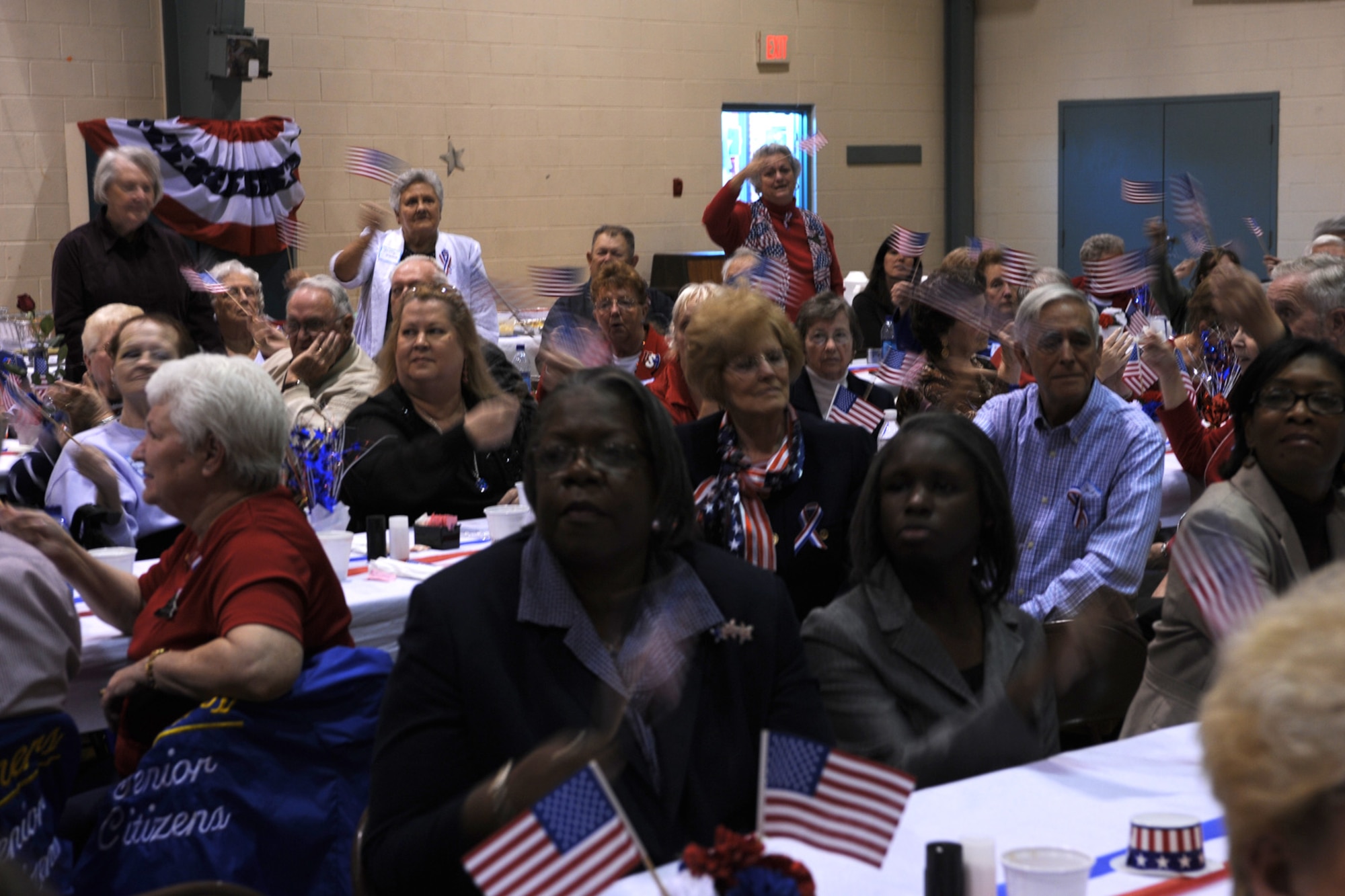 LANGLEY AIR FORCE BASE, Va. – Chesapeake residents and veterans stand during the playing of their branch of service’s song, during an early Veterans Day celebration hosted by the Niners Senior Citizens of Chesapeake Nov. 5.  Military members from each branch of service lit candles to honor their branch’s fallen, and exchanged roses with veterans during the ceremony to honor past, present and fallen military members.  (U.S. Air Force photo/Staff Sgt. Christina M. Styer)