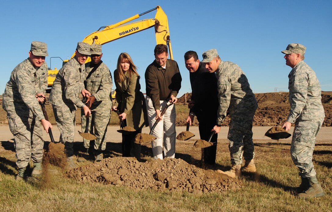 ELLSWORTH AFB S.D. -- (Left to right) Col. Jeffrey Taliaferro, 28th Bomb Wing commander, Col. Steven Hiss, 28 BW vice commander, Chief Master Sgt Clifton Cole, 28 BW command chief, Ms. Tania Schepper, representing Congresswoman Herseth Sandlin, Mr. Darrell Shoemaker, representing Senator Johnson, Mr. Qusi Al`Haj, representing Senator Thune, Lt. Col. Matthew Joganich, 28th Civil Engineer Squadron commander and Col. Michael Yuill, 28th Mission Support Group commander, finish off the new gate ground breaking event with just a little dirt, Nov. 5.  The new gate will replace the Patriot Gate. (U.S. Air Force photo/Airman 1st Class Anthony Sanchelli)
