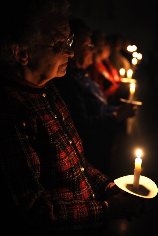 LANGLEY AIR FORCE BASE, Va. – Vivian Hodges, Niners Senior Citizens of Chesapeake, participates in a candlelight vigil honoring our nation’s fallen Service members during an early Veterans Day celebration, hosted by the Niners Senior Citizens of Chesapeake Nov. 5.  Military members from each branch of service lit candles to honor their branch’s fallen, and exchanged roses with veterans during the ceremony to honor past, present and fallen military members.  (U.S. Air Force photo/Staff Sgt. Christina M. Styer)