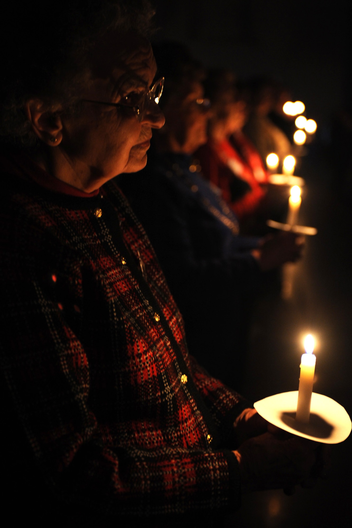 LANGLEY AIR FORCE BASE, Va. – Vivian Hodges, Niners Senior Citizens of Chesapeake, participates in a candlelight vigil honoring our nation’s fallen Service members during an early Veterans Day celebration, hosted by the Niners Senior Citizens of Chesapeake Nov. 5.  Military members from each branch of service lit candles to honor their branch’s fallen, and exchanged roses with veterans during the ceremony to honor past, present and fallen military members.  (U.S. Air Force photo/Staff Sgt. Christina M. Styer)