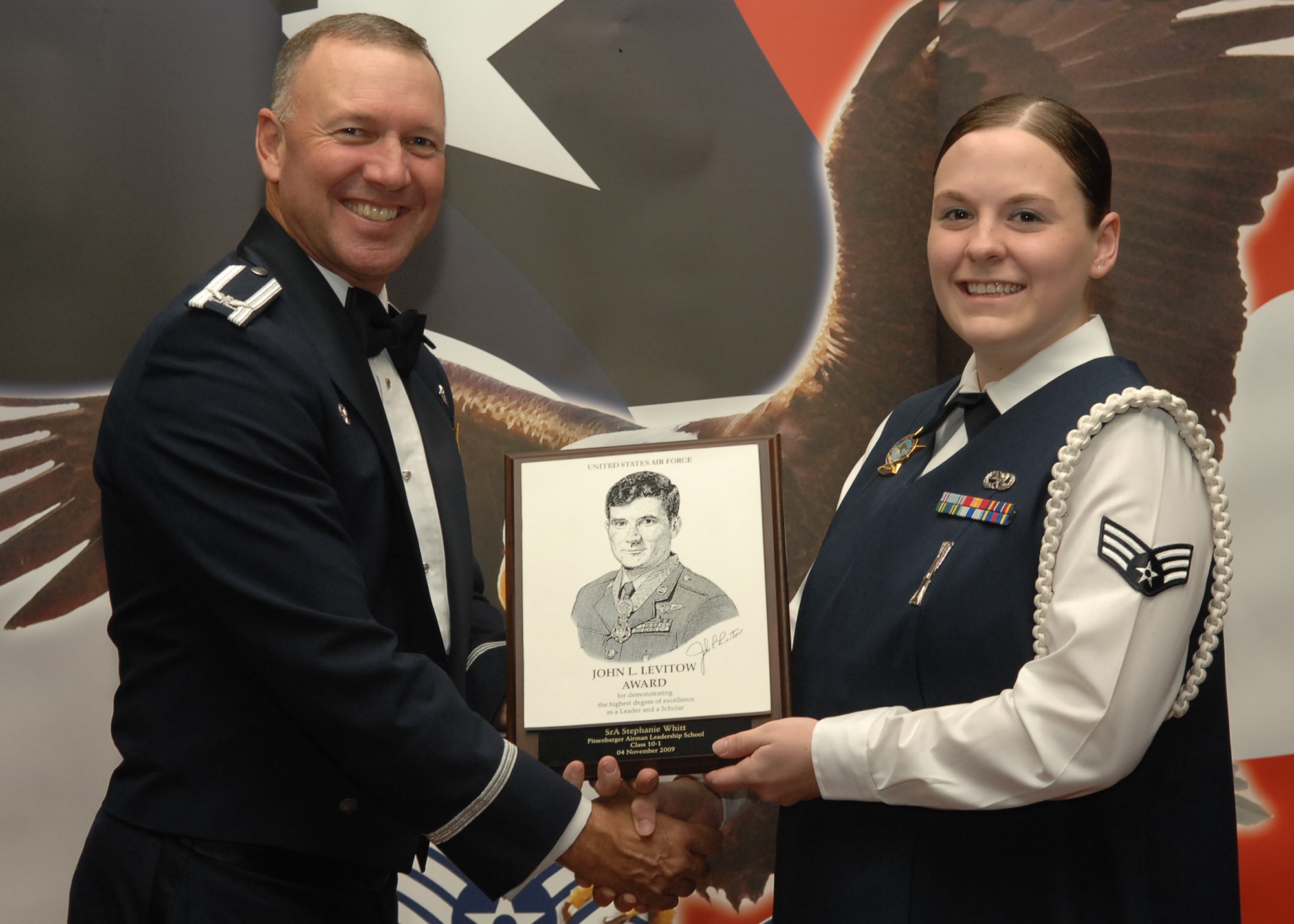 SPANGDAHLEM AIR BASE, Germany – Col. Tip Wight, 52nd Fighter Wing commander, presents the John L. Levitow Award to Senior Airman Stephanie Witt, 52nd Communications Squadron, during the Airman Leadership School class 10-1 graduation Nov. 5 at Club Eifel. The John L. Levitow Award is the premier honor given to the finest graduate of every Air Force Leadership School. (U.S. Air Force photo/Airman 1st Class Nick Wilson)