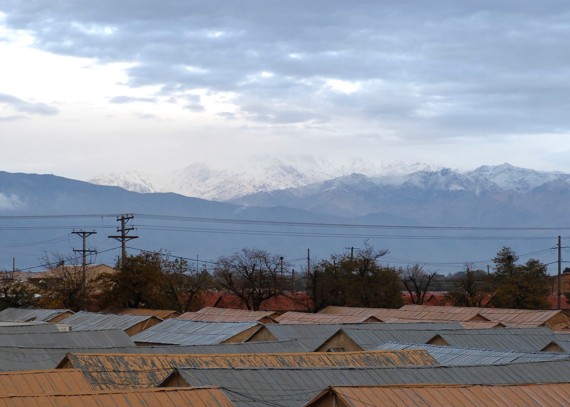 BAGRAM AIRFIELD, Afghanistan -- The sun attempts to shine through the clouds onto the mountains in Afghanistan Nov. 9, 2009.  The high altitude of the Hindu Kush mountain range creates a harsh climate ranging from more than 100 degrees Fahrenheit in the summer to below-freezing temperatures in the winter.  (U.S. Air Force photo/Senior Airman Felicia Juenke)