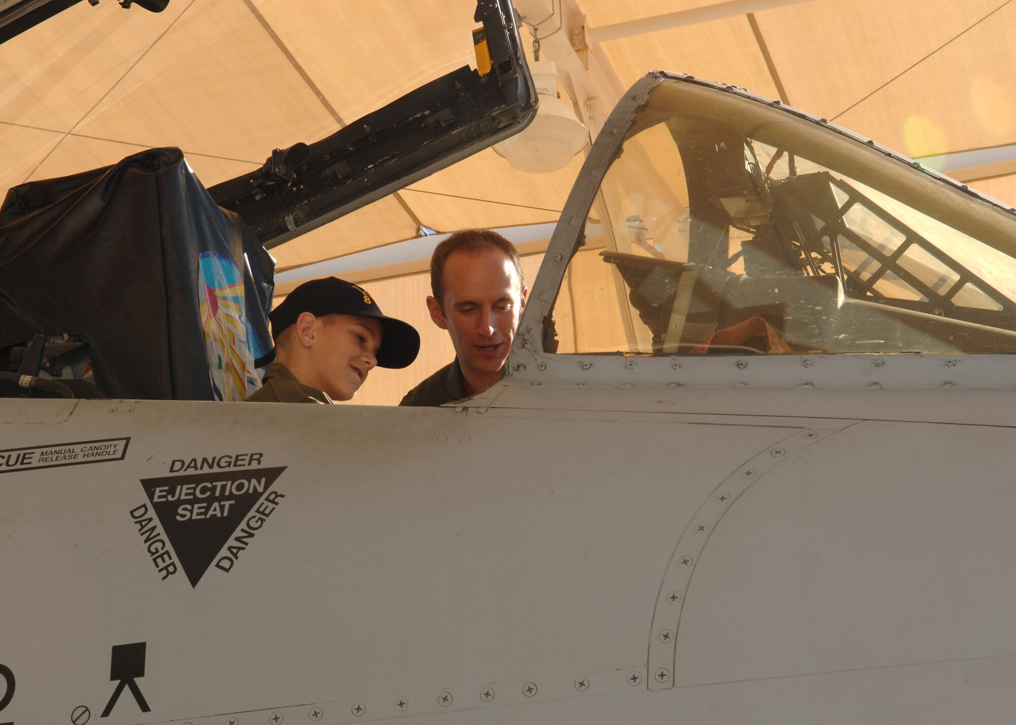 This months Pilot for a Day participant James Whipp, 12, takes a seat in the cockpit of an A-10 here Oct. 16. Accompanied by his pilot counterpart Capt. Jeff "Narco" Burley, 358th Fighter Squadron, James and his family took a tour of the base and several of the aircraft to include an A-10 Thunderbolt, an HH-60 Pavehawk and a C-130 Hercules. (U.S. Air Force photo/Airman Jerilyn Quintanilla)