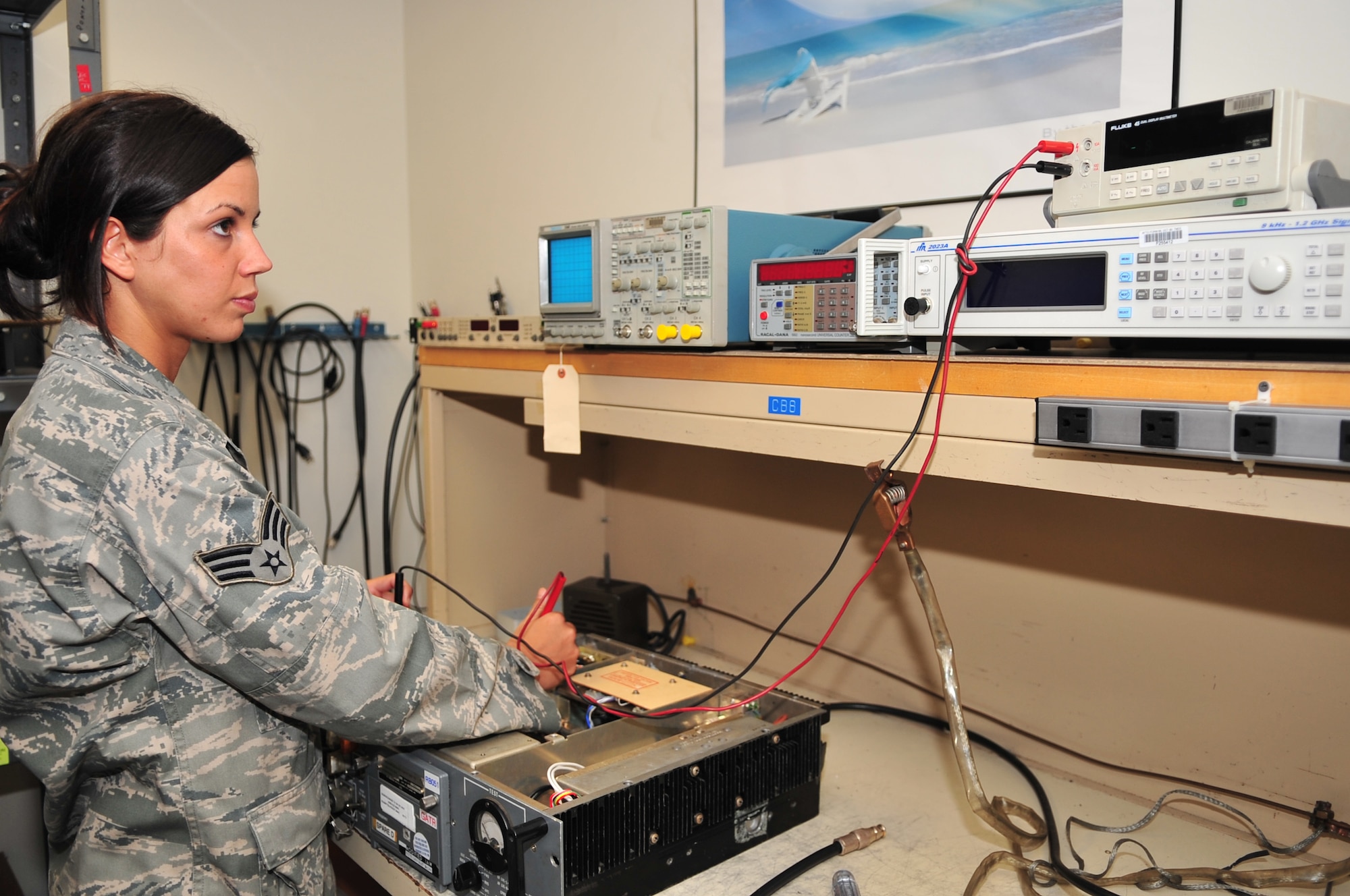 Senior Airman Tashia Kamper, 4th Communication Squadron airfield systems apprentice, checks the voltage on a UHF transmitter used in the air traffic control tower on Seymour Johnson Air Force Base, N.C., Nov. 5, 2009. The UHF transmitter is used to communicate with aircraft in the airspace. Airman Kamper is originally from St. Louis. (U.S. Air Force photo/Airman 1st Class Rae Perry)