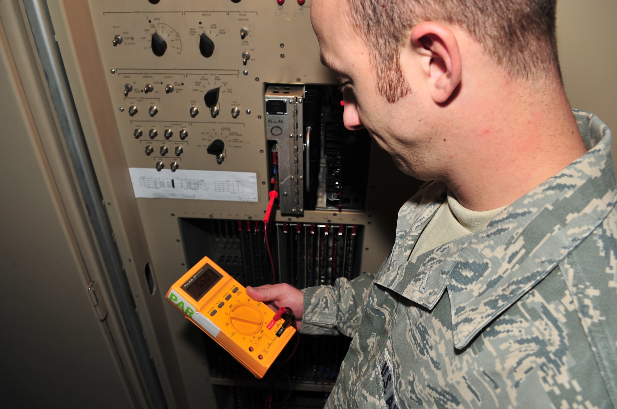 Airman 1st Class Joshua Dishner, 4th Communications Squadron air traffic control radar apprentice, uses a volt meter to check electrical output of a video processor in a GPN-20 airport surveillance radar on Seymour Johnson Air Force Base, N.C., Nov. 5, 2009. The radar is part of the Federal Aviation Administration's national airspace, in order to maintain these standards, the communication specialist perform a weekly check to ensure it is functioning properly. Airman Dishner is originally from Bristol, Tenn. (U.S. Air Force photo/Airman 1st Class Rae Perry) 