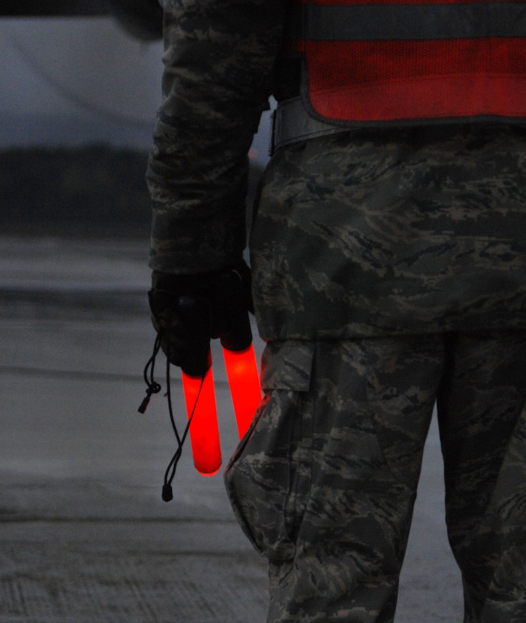 Master Sgt. Jeff Hardsock, 302nd Airlift Wing crew chief, waits in the early morning mist before marshaling a plane for departure on Ramstein Air Base, Germany Nov. 9, 2009. Master Sgt. Hardsock along with members of the 302nd Airlift Wing, an Air Force Reserve unit from Peterson Air Force Base, Colo. is deployed at Ramstein Air Base in support of Operation Joint Enterprise. (U.S. Air Force photo by Airman 1st Class Brittany Perry)