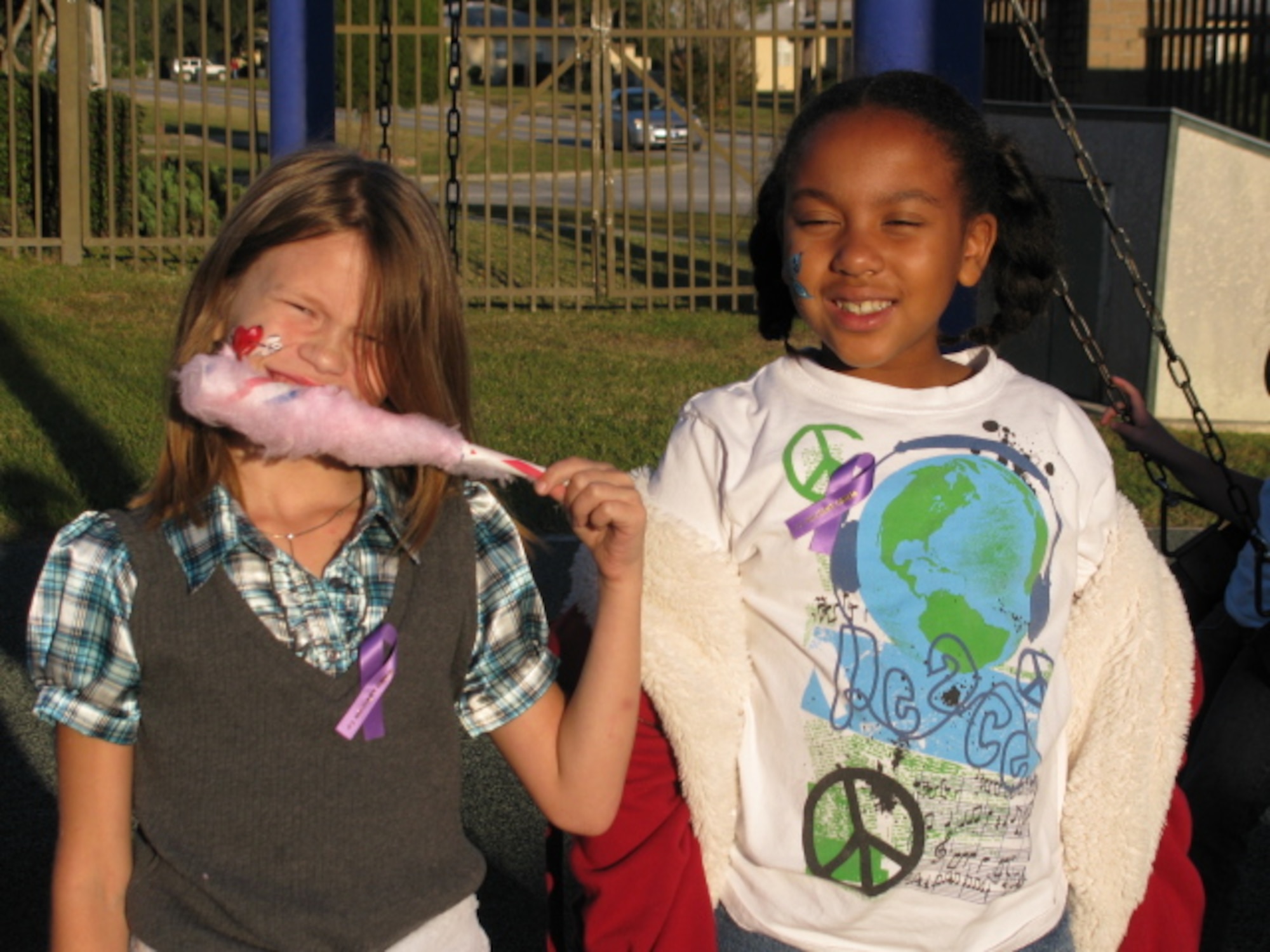 EGLIN AIR FORCE BASE, Fla. -- Two girls at the School Age Program Fall Festival Nov. 6 enjoy cotton candy and show off their "#1 Military Child" ribbon. Ribbons were handed out Eglin Elementary, Child Development Centers, SAP and Youth Center during the Week of the Air Force Family. (U.S. Air Force by photo by Marcy Silvia)