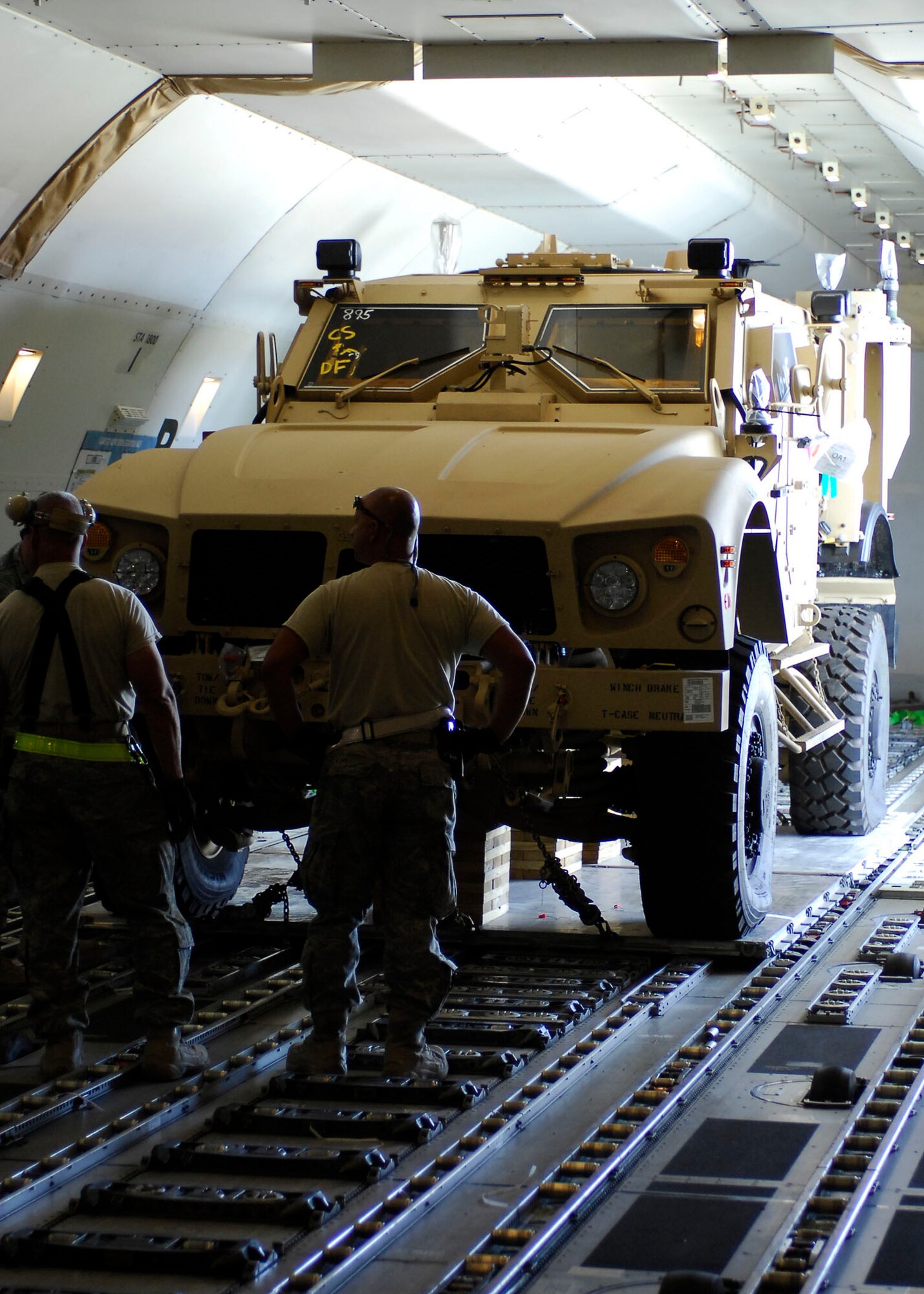 BAGRAM AIRFIELD, Afghanistan -- Airmen, from the 455th Expeditionary Aerial Port Squadron, wait to unload a Multipurpose All Terrain Vehicles from a 747 Nov. 9, 2009.  The M-ATVs support mounted patrols, reconnaissance, security, convoy protection, communications, command and control, and combat service support. The M-ATV is designed to replace the up-armored Humvee in Afghanistan.  (U.S. Air Force photo/Senior Airman Felicia Juenke)