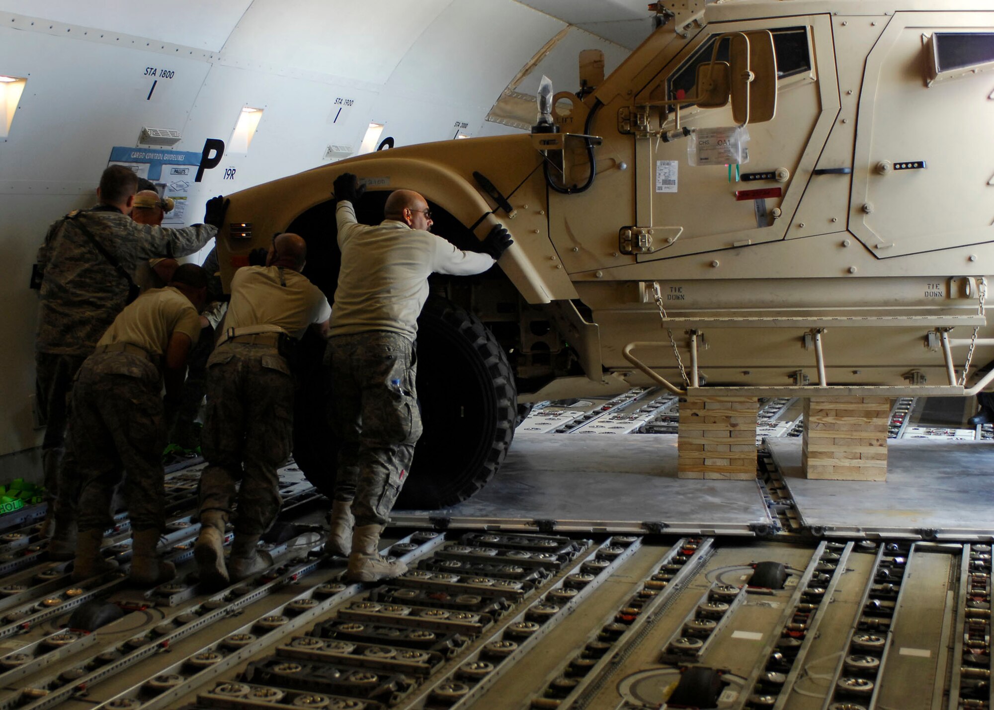 BAGRAM AIRFIELD, Afghanistan -- Members of the 455th Expeditionary Aerial Port Squadron, known as "Port Dawgs," assist in unloading Multipurpose All Terrain Vehicles Nov. 9, 2009.  The M-ATVs were flown in on a 747 and are designed to replace the up-armored Humvee in Afghanistan.  The M-ATVs support small-unit combat operations in highly restricted rural, mountainous and urban environments.  (U.S. Air Force photo/Senior Airman Felicia Juenke)